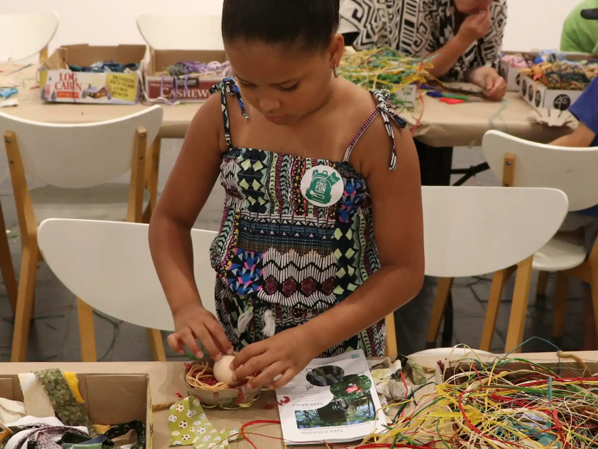a person sitting at a table with a box of candy