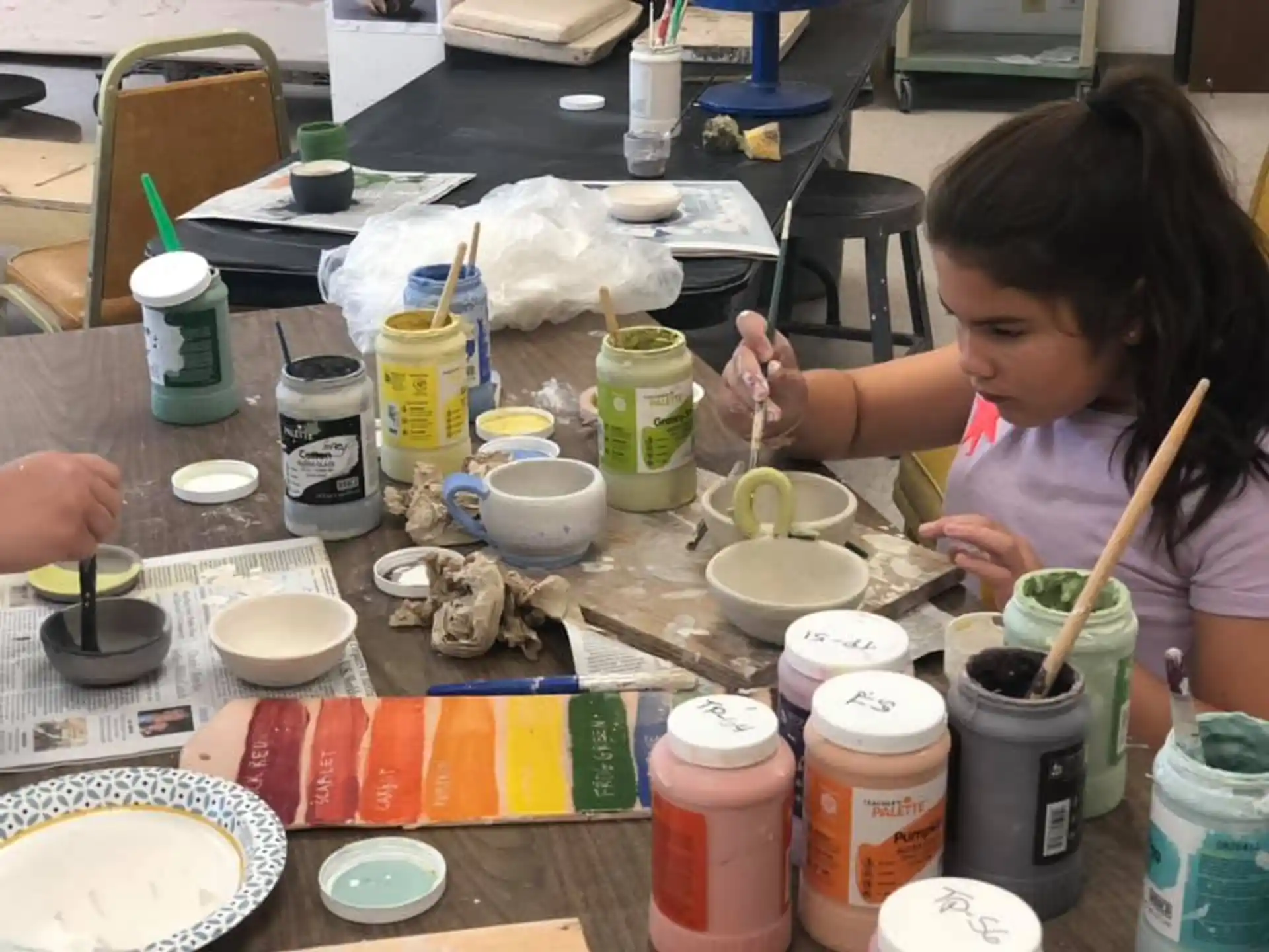 a girl painting on a table