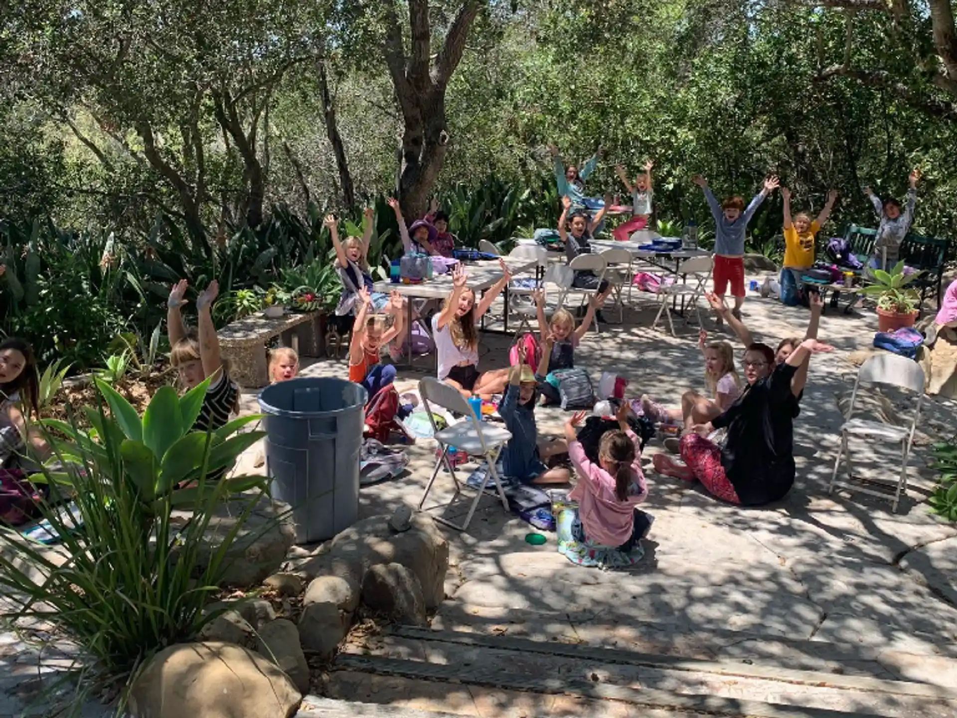 a group of people sitting on a beach