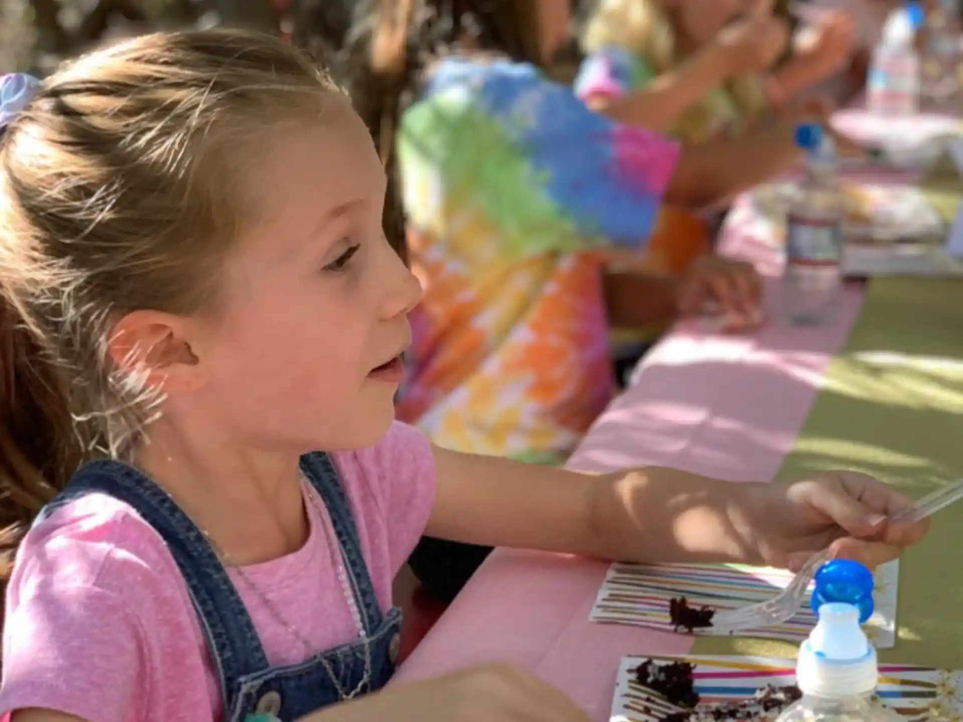 a young girl sitting at a table