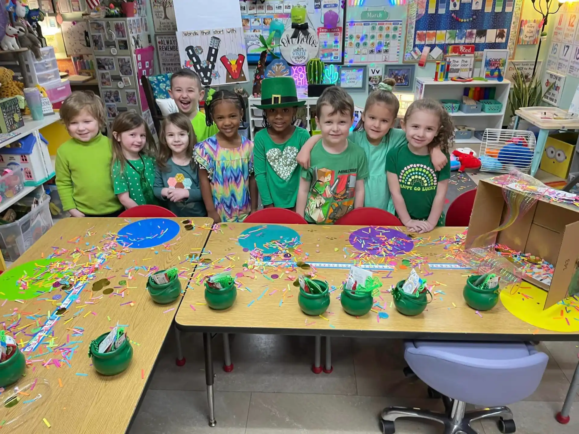 a group of children wearing green hats