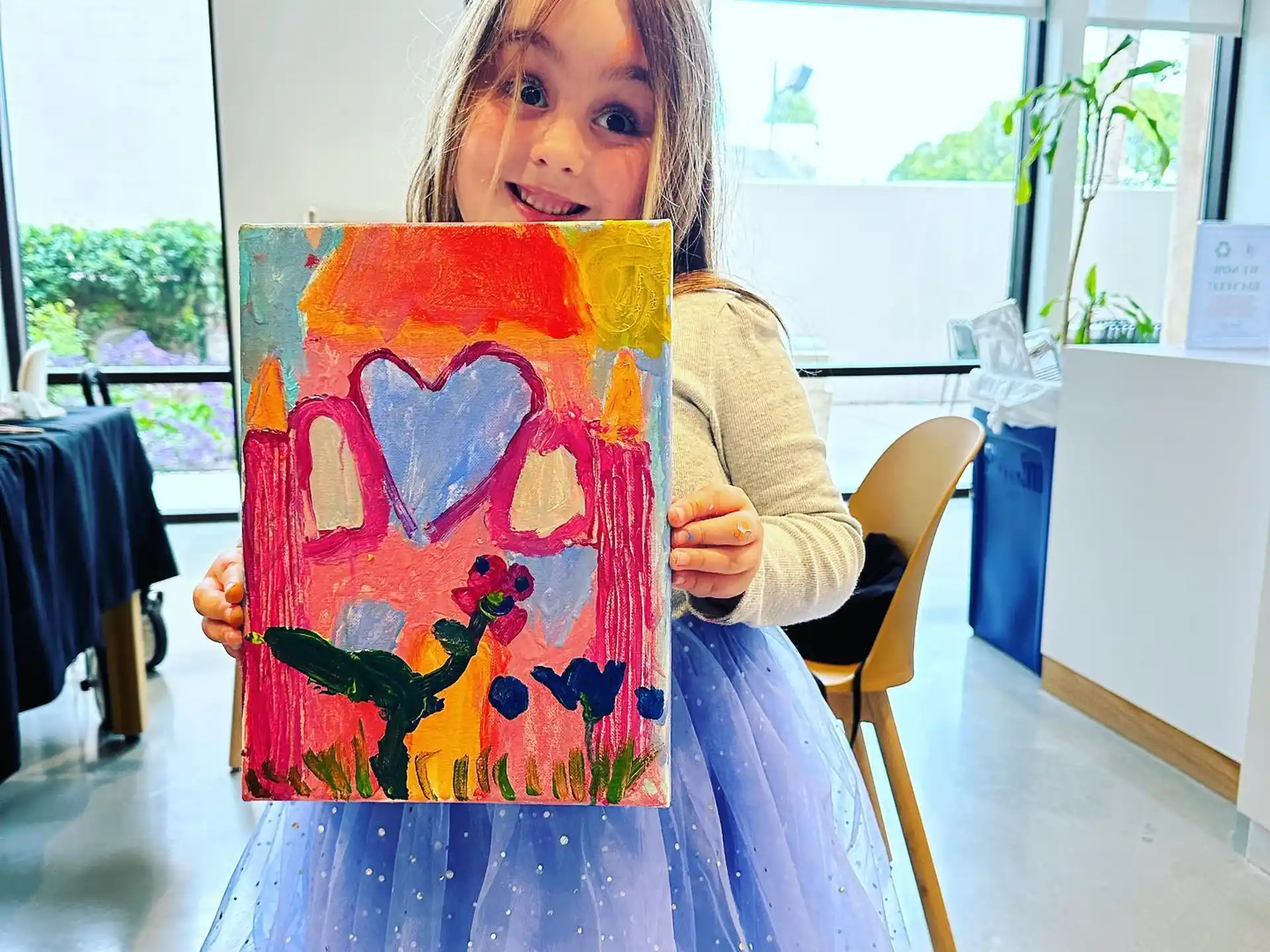 a girl holding a painting