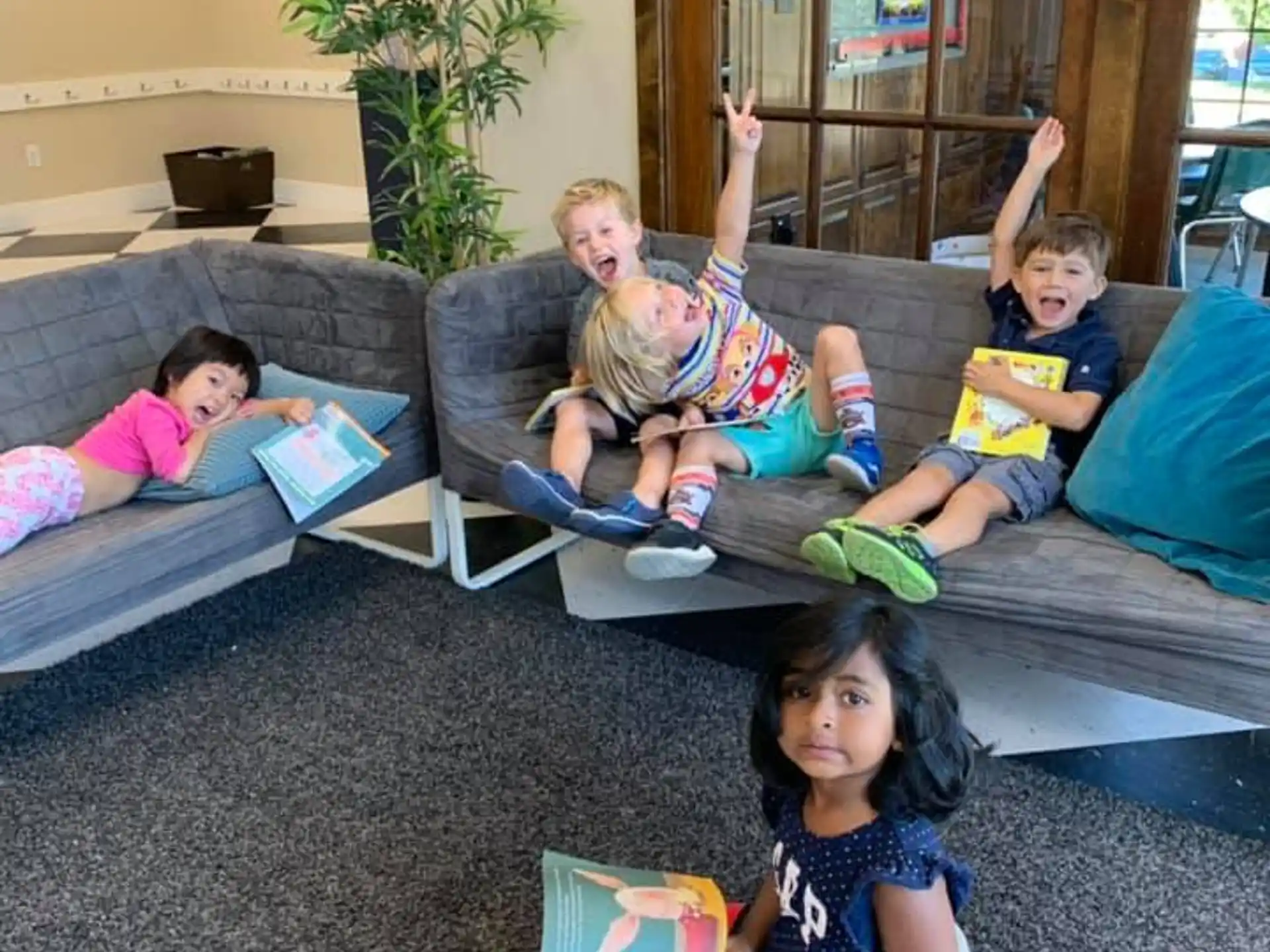 a group of children sitting on the floor reading books
