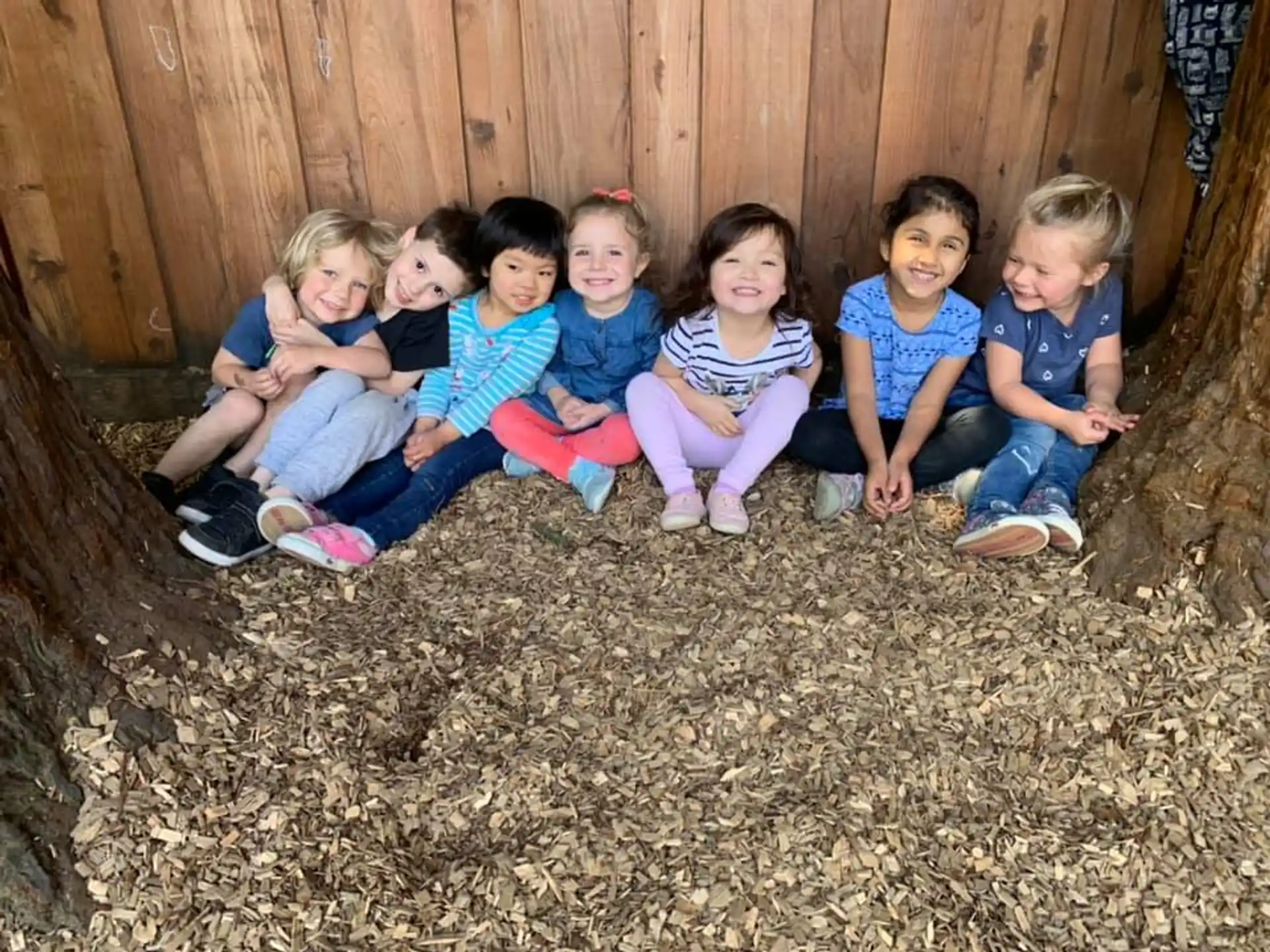 a group of children sitting on the ground