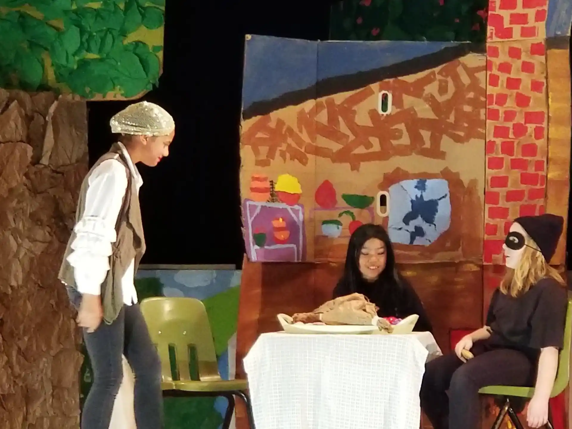 a man standing next to a table with a woman sitting at it