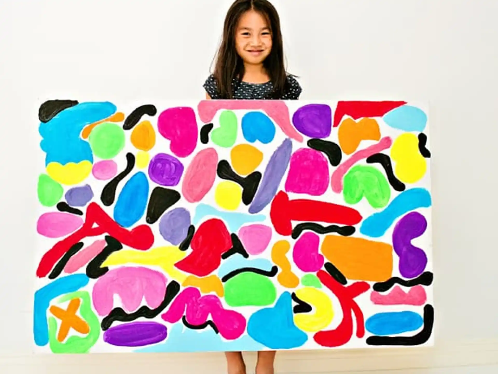 a person holding a large piece of art