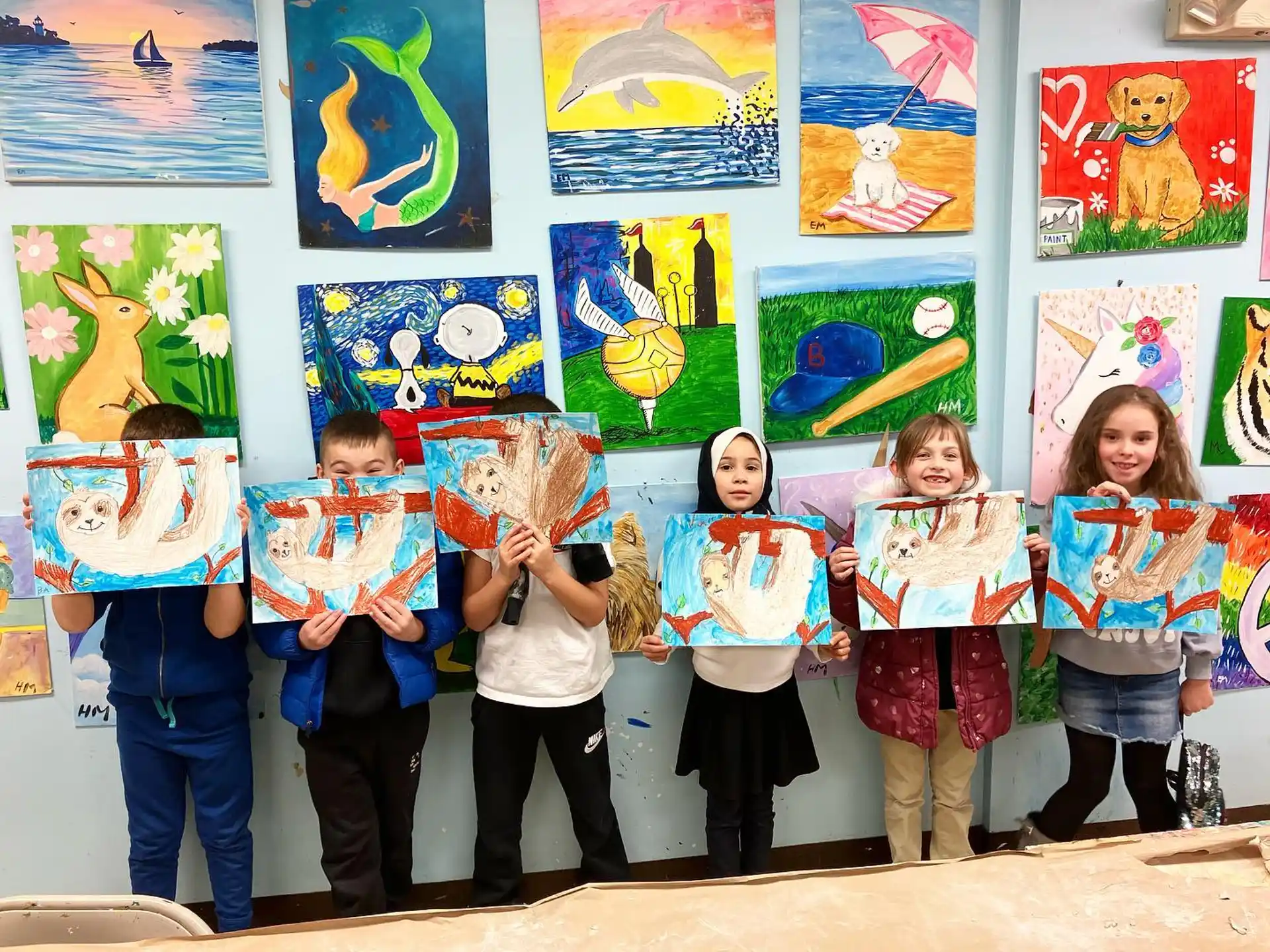 a group of children holding up posters