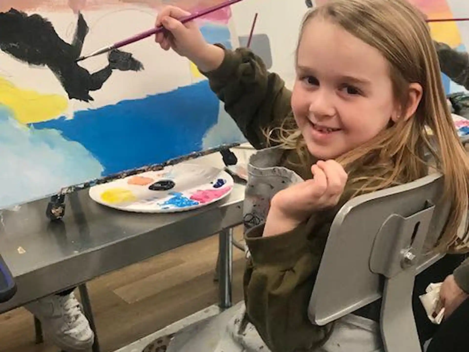 a girl painting on a table