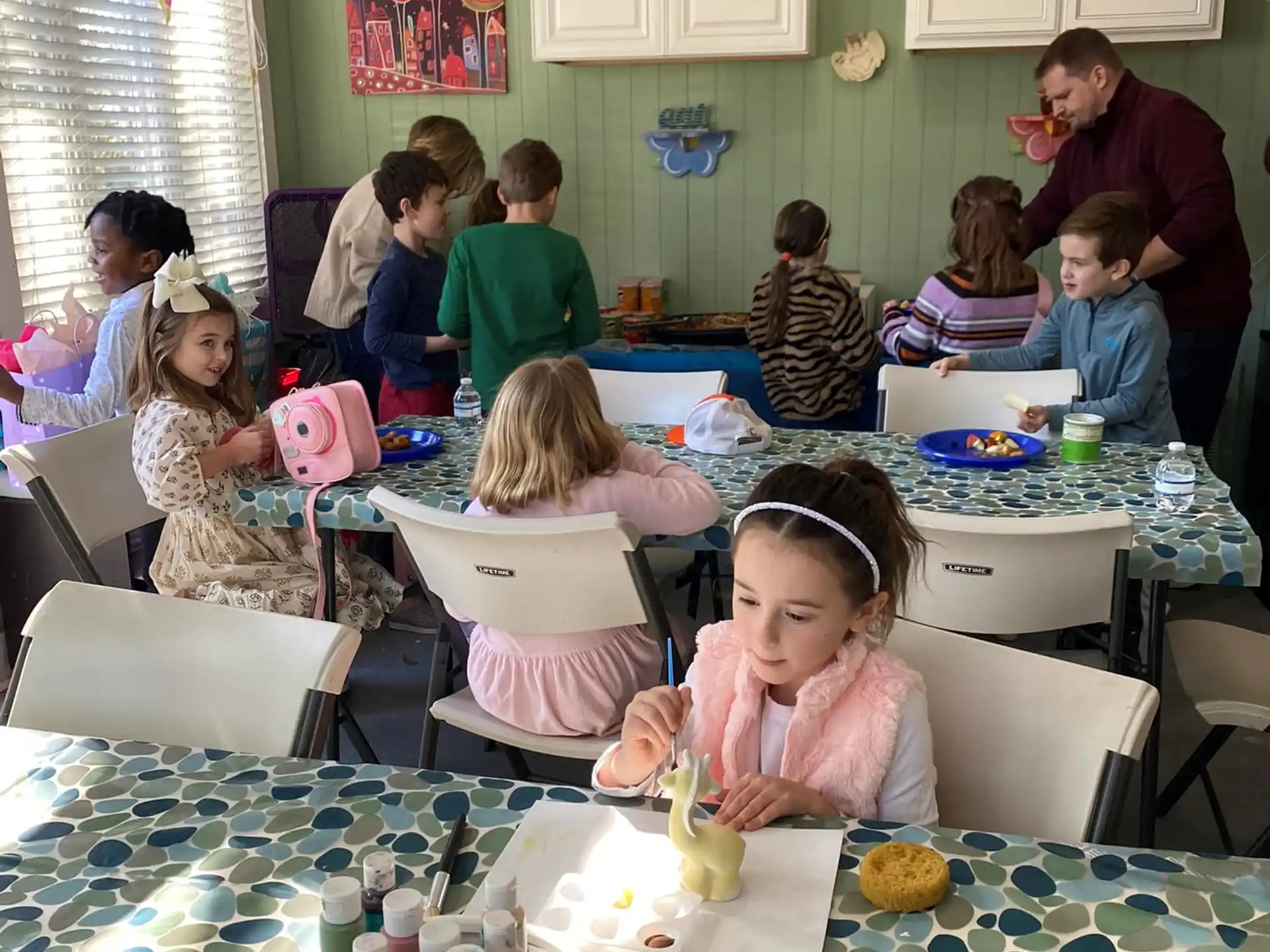 a group of children sitting at a table