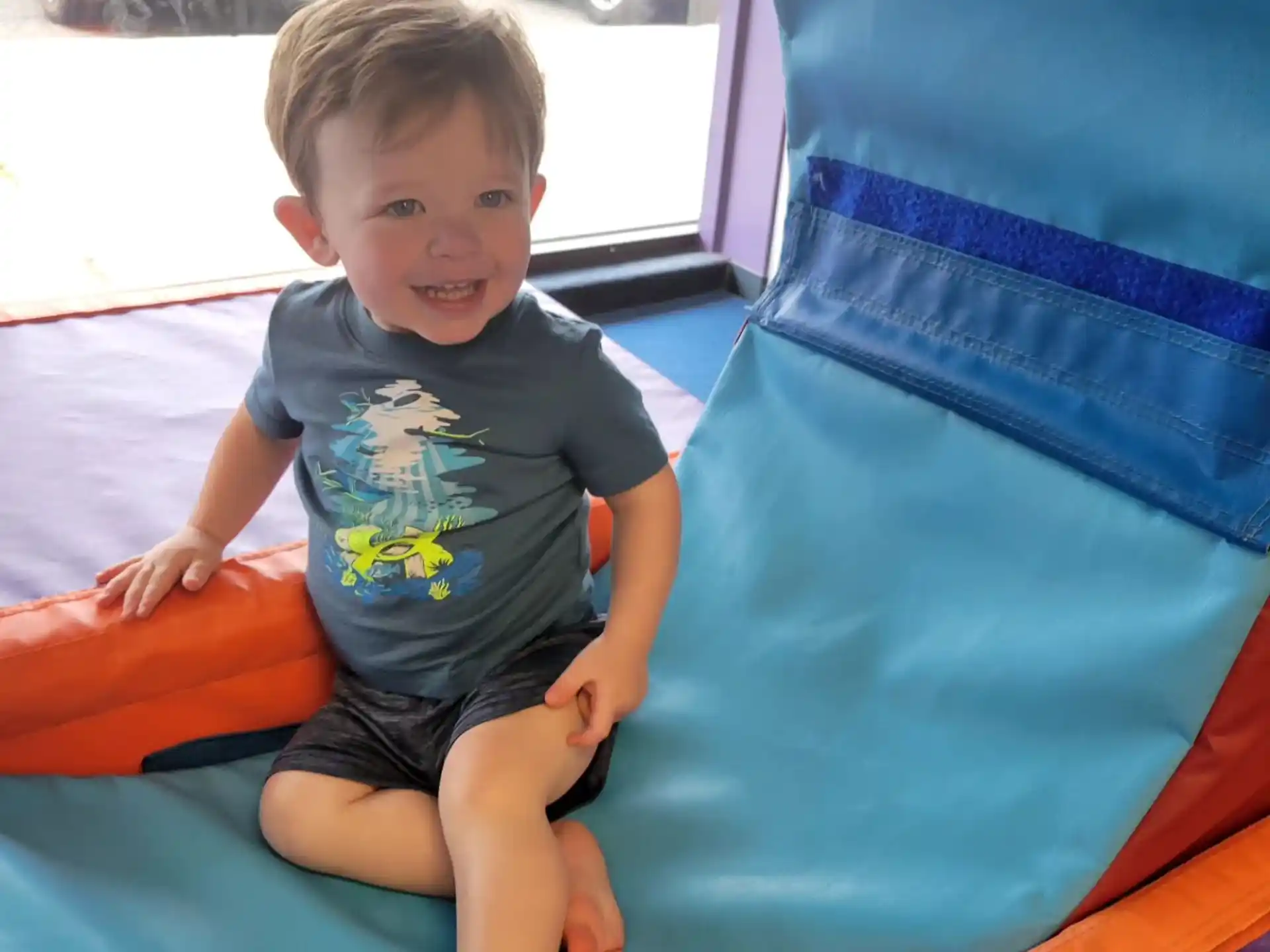 a boy sitting on a slide