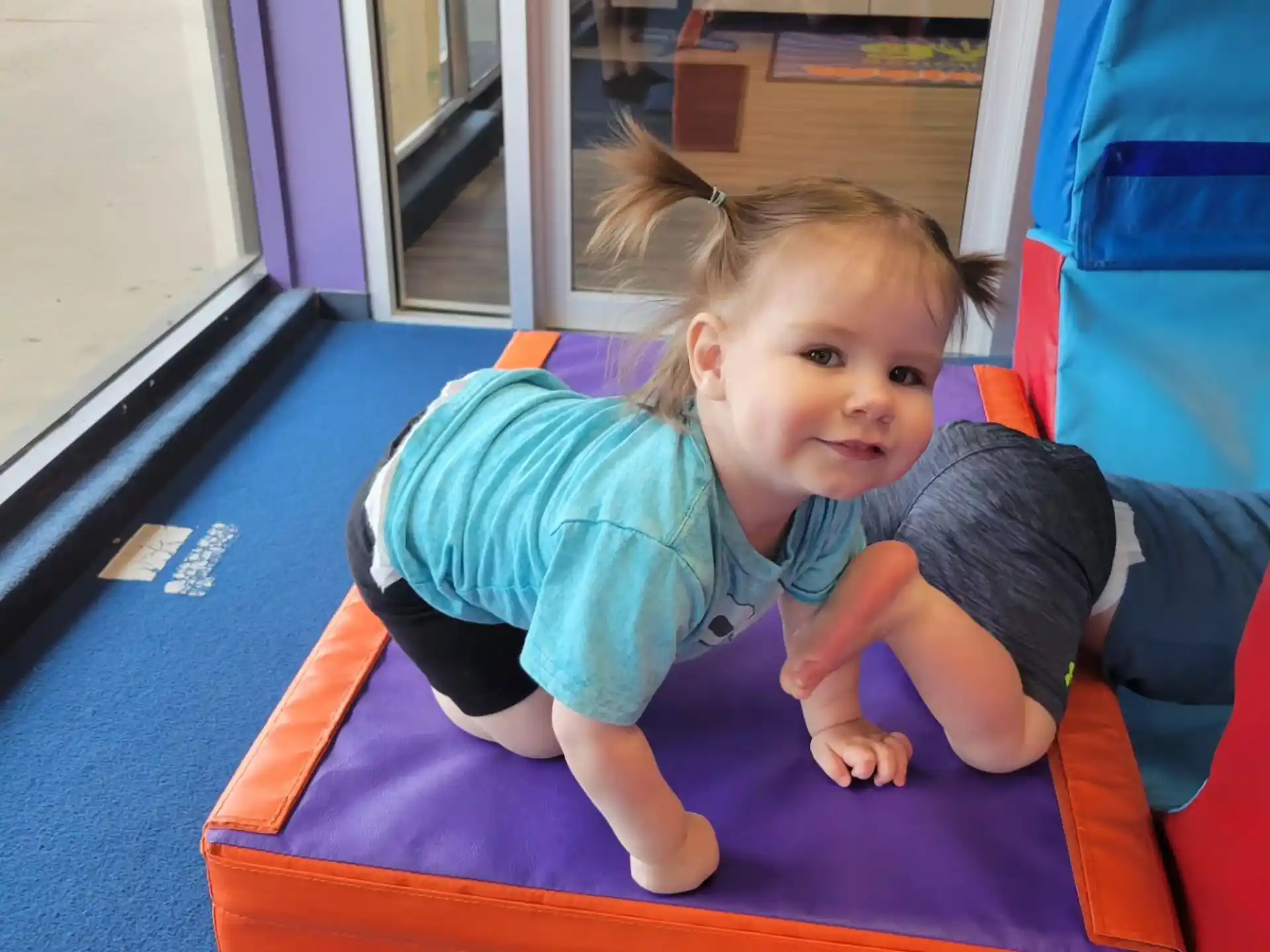 a girl sitting on a mat