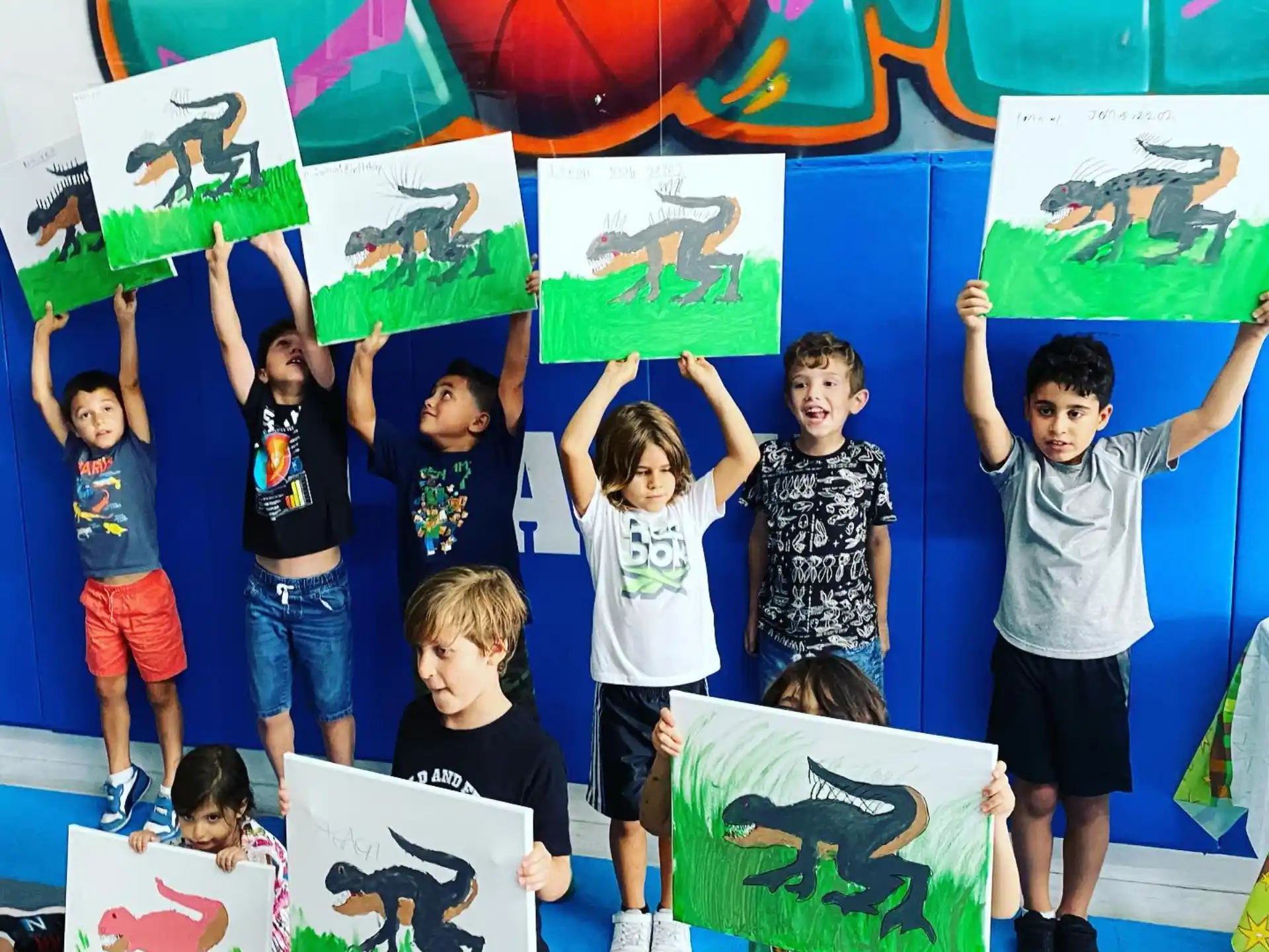 a group of kids holding up posters