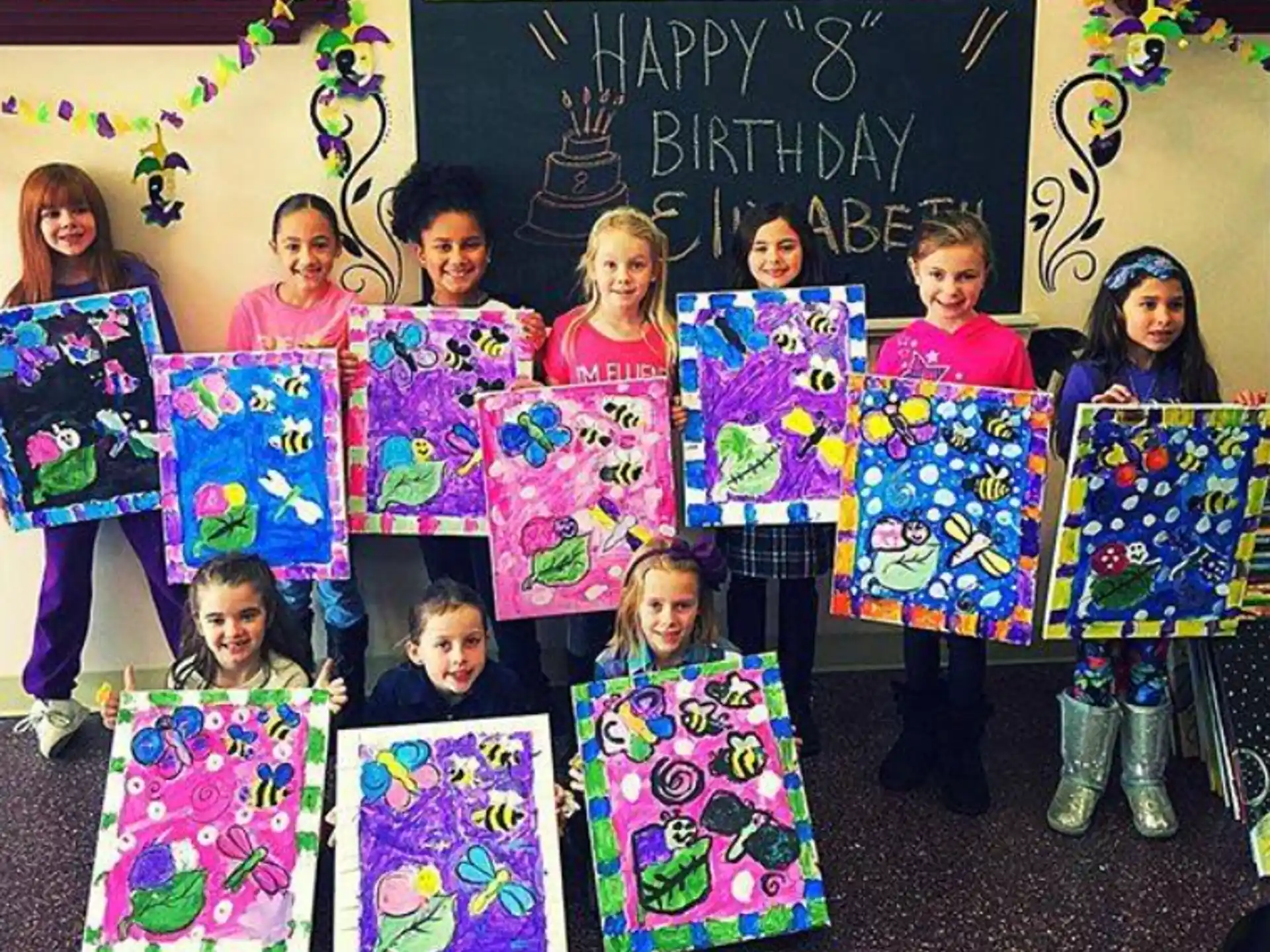 a group of children holding up colorful paper signs