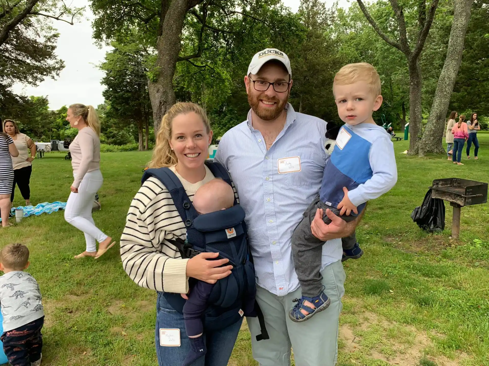 a man and woman holding a baby