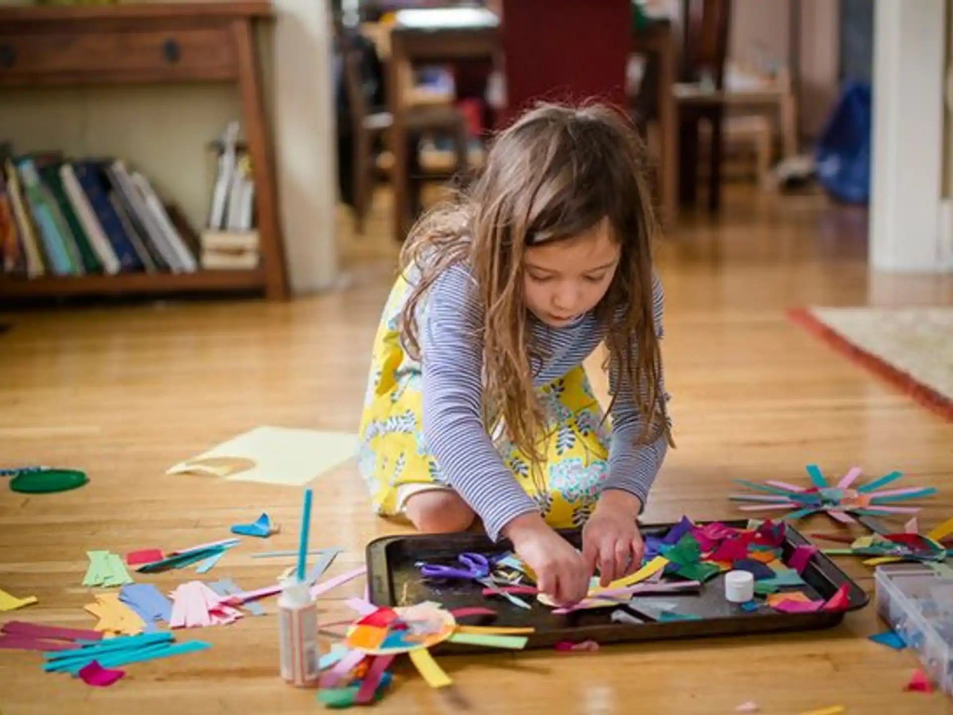 a girl coloring on a paper