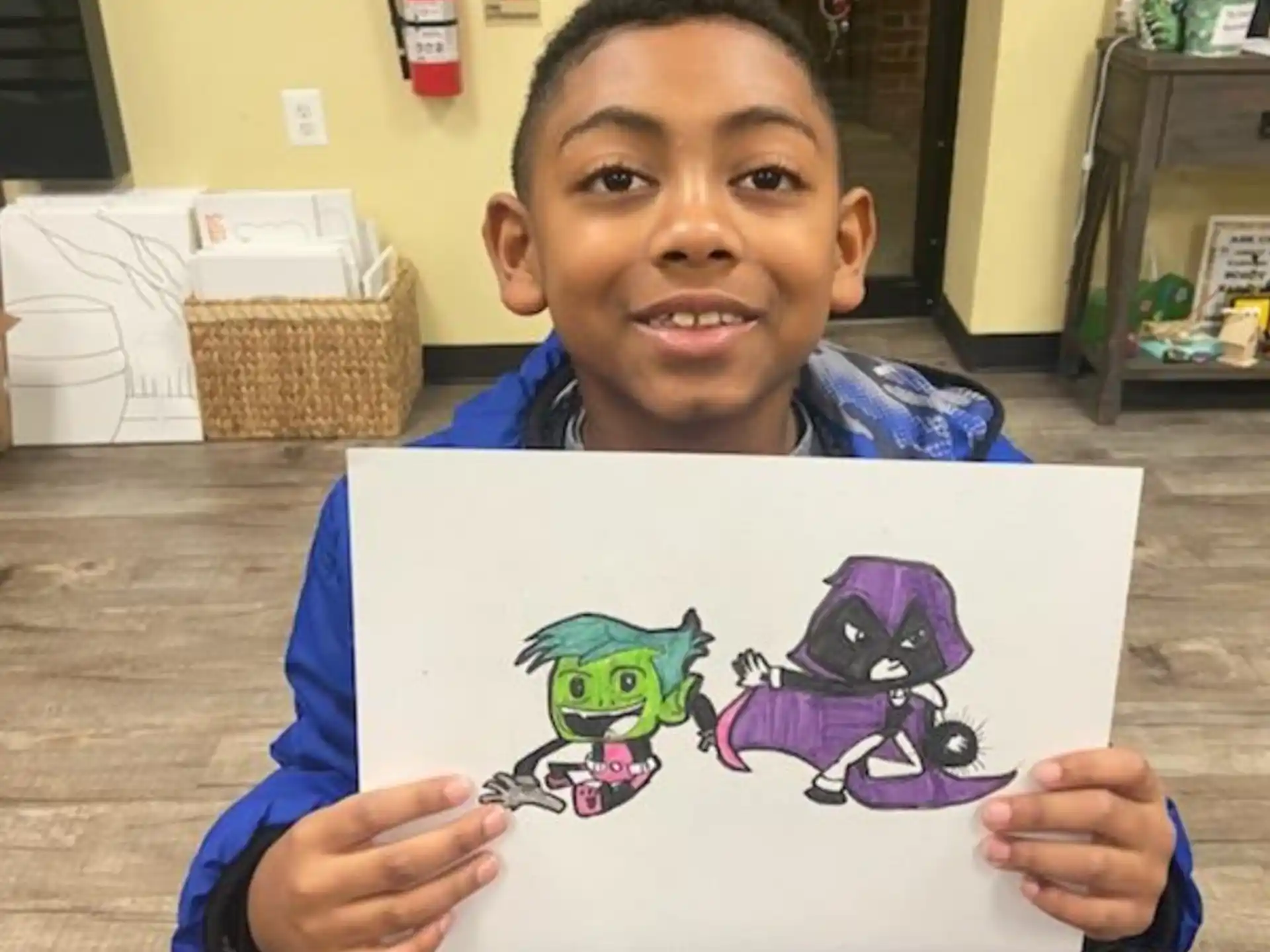 a boy holding a drawing