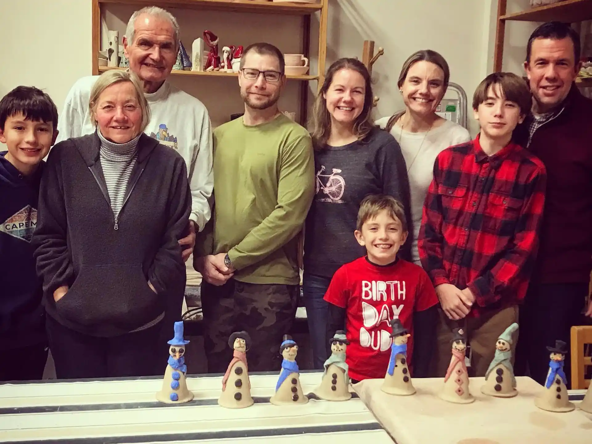 a group of people posing for a photo with a chess board