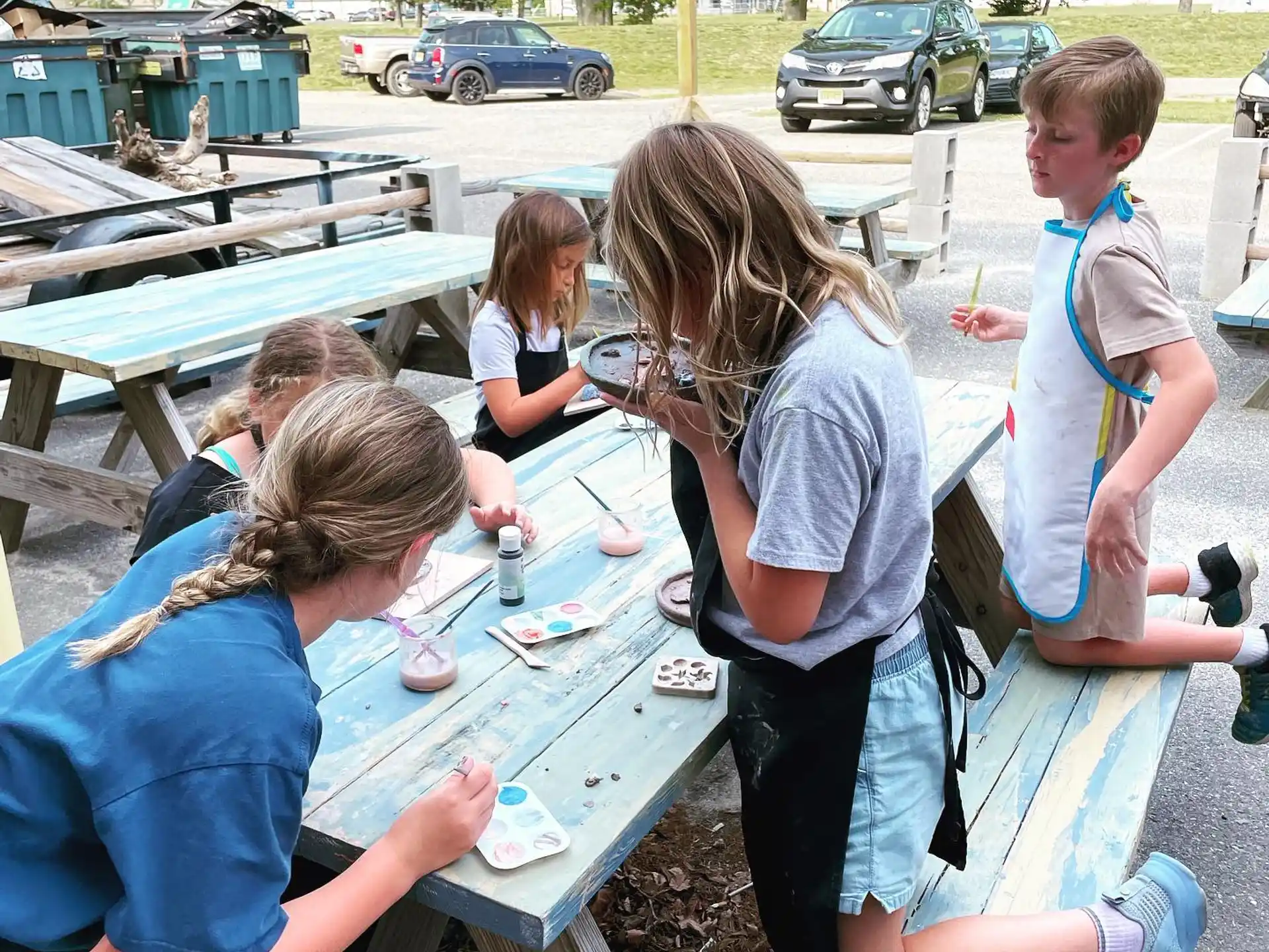 a group of people sitting at a table outside
