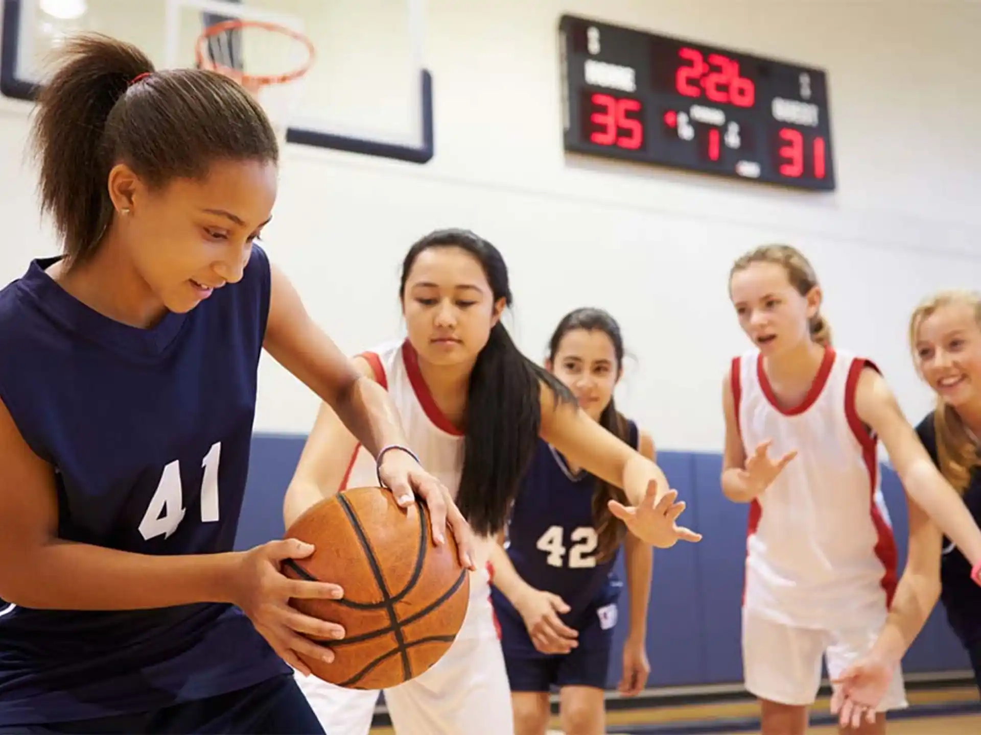 a group of women playing basketball
