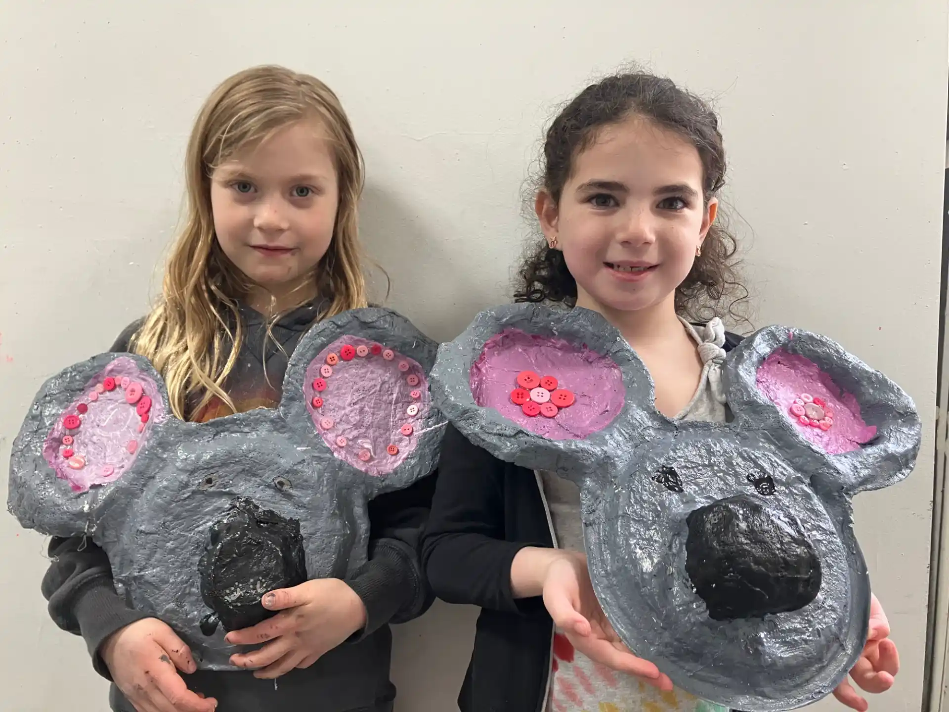 girls holding a stuffed animal