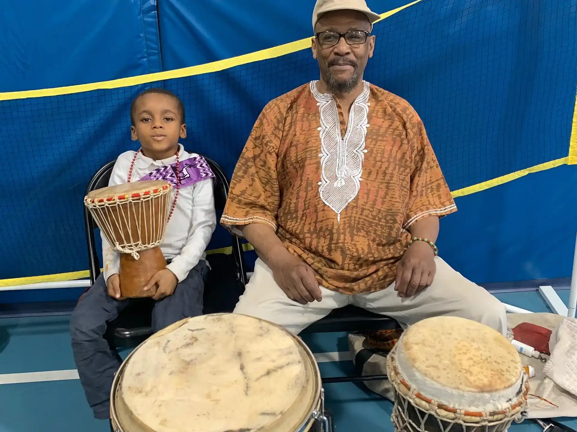 a person and a child playing drums