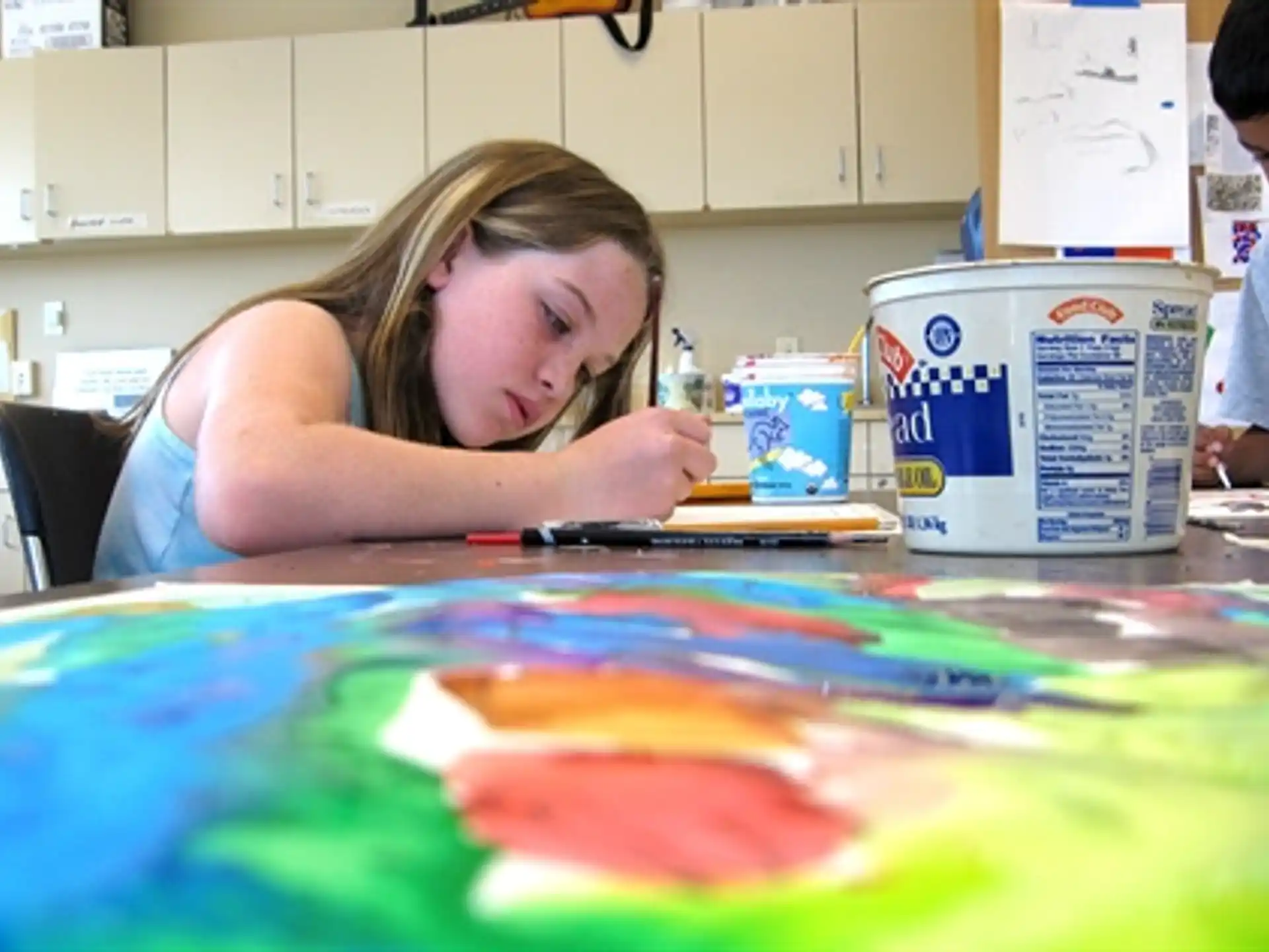 a girl painting on a table