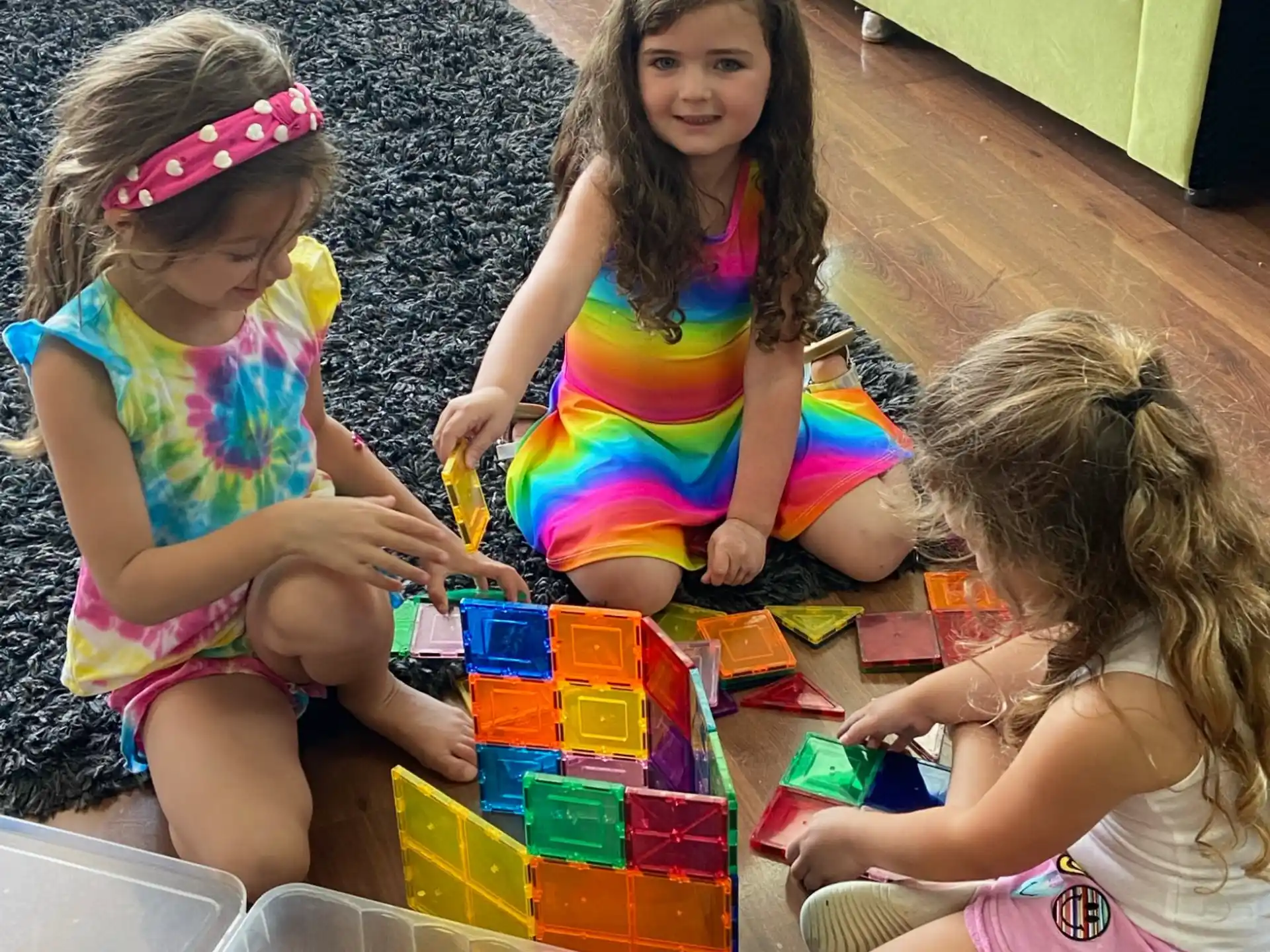 a group of girls playing with toys