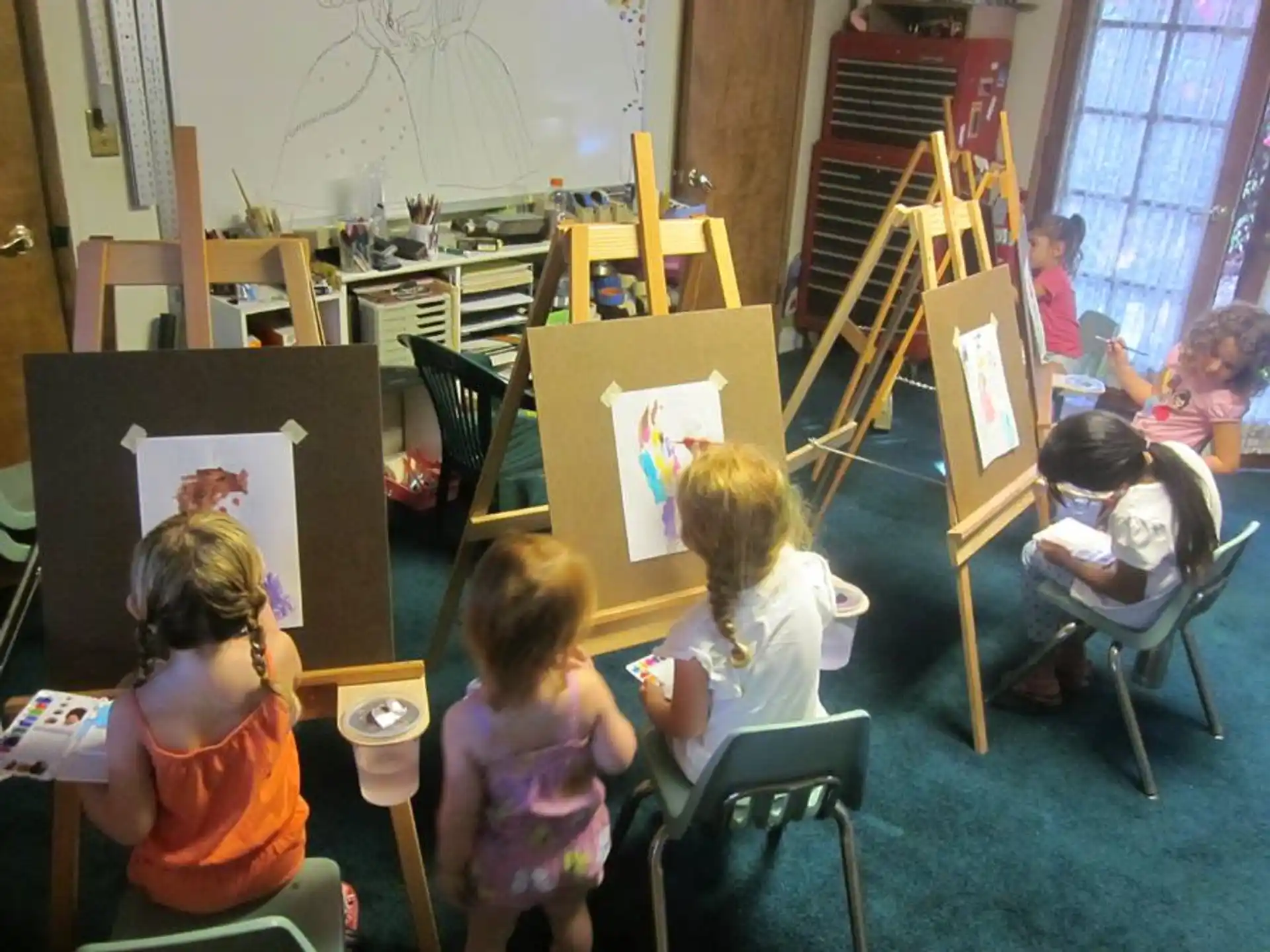 a group of children sitting in a classroom