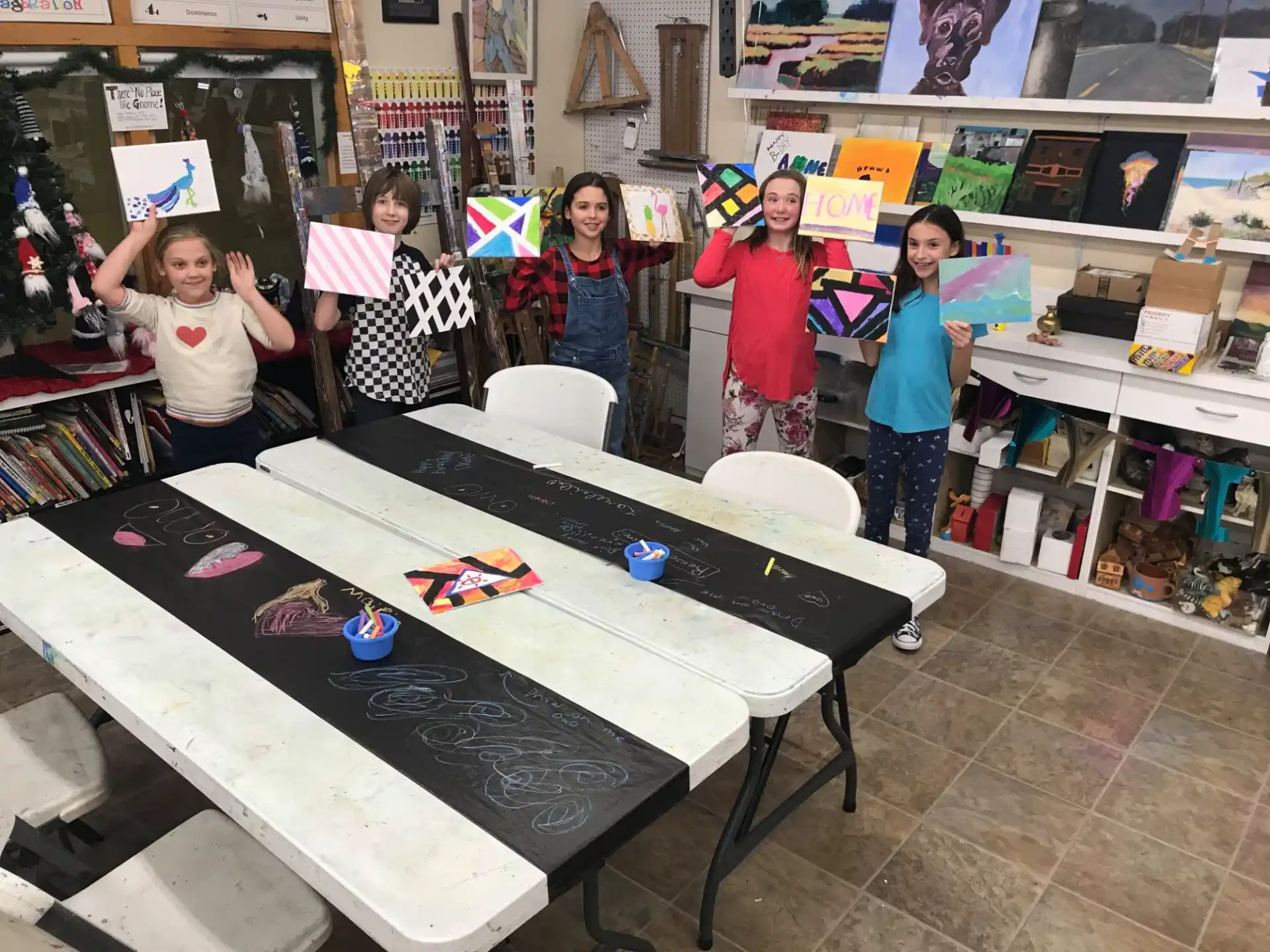 a group of children standing around a table with a game on it