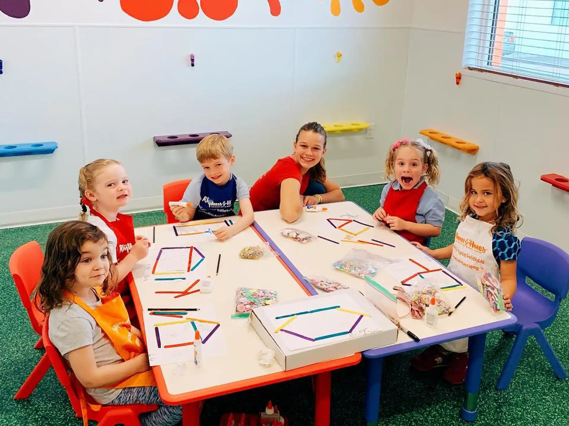 a group of children sitting around a table