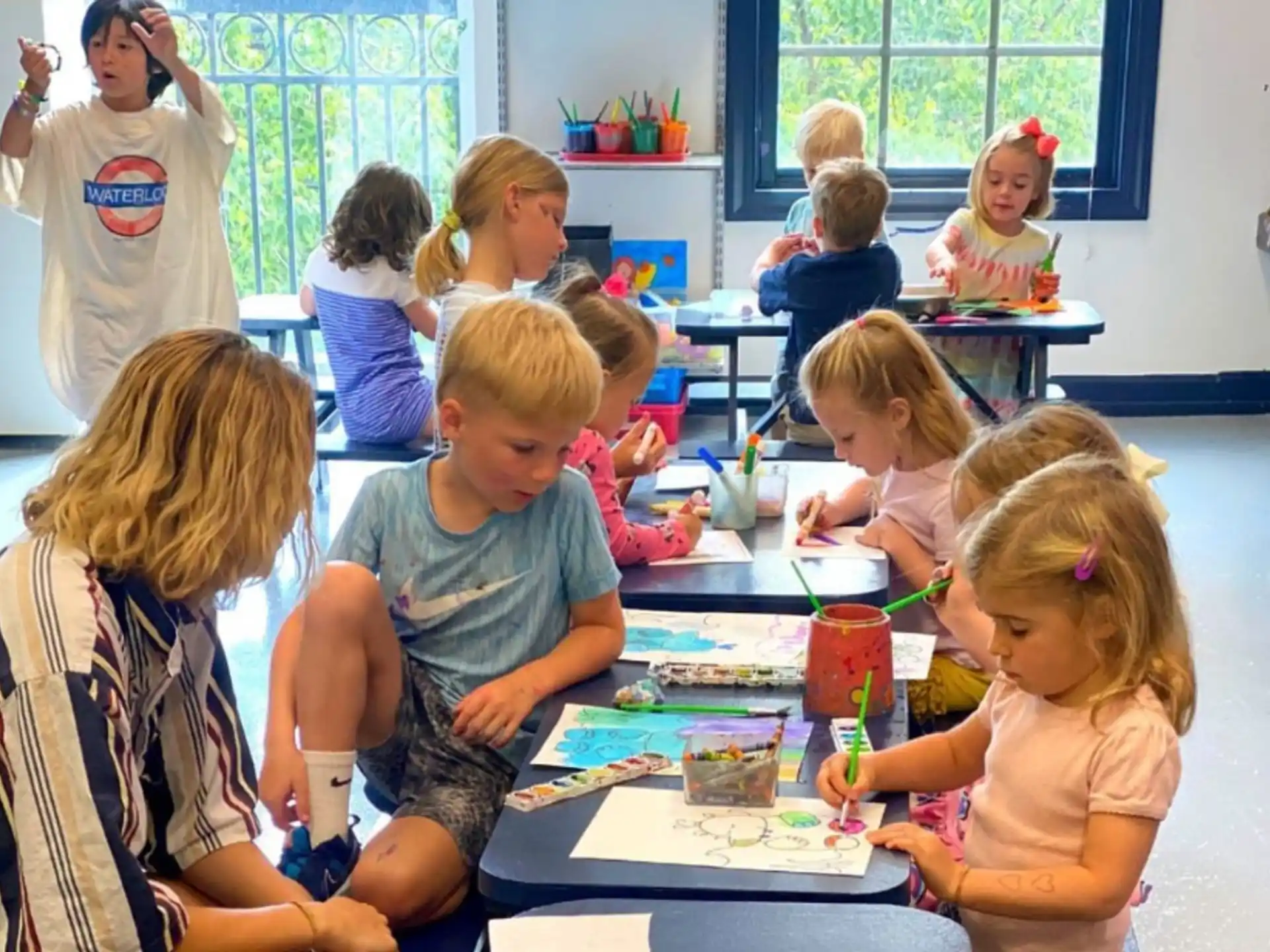 a group of children sitting at a table
