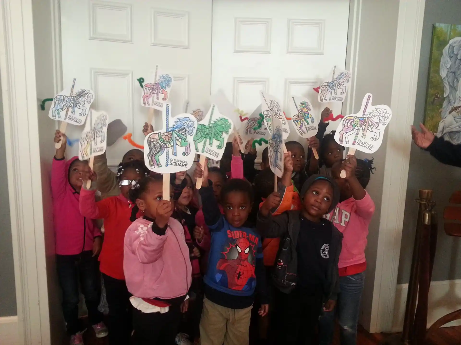a group of children holding paper signs