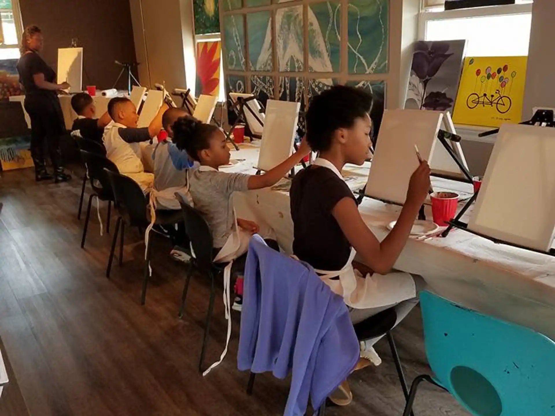 a group of children sitting at desks in a classroom