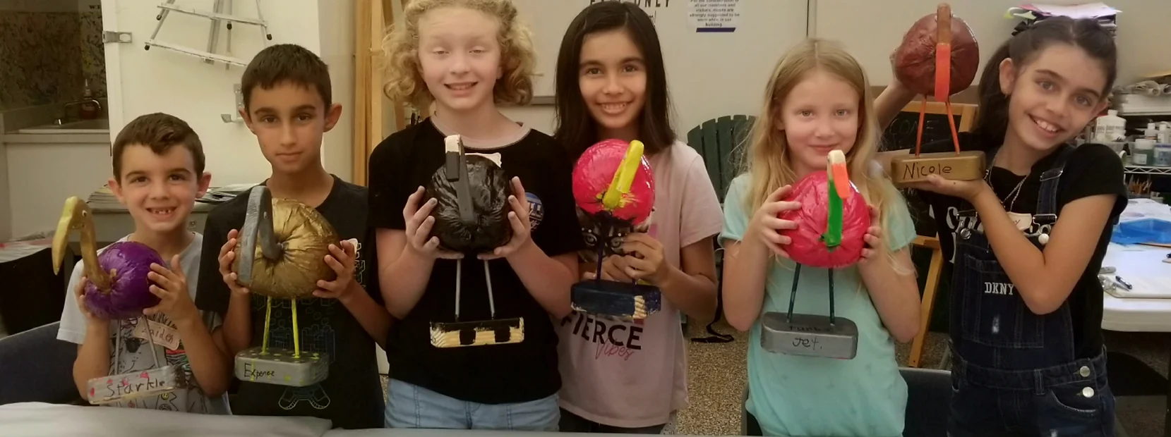a group of kids holding up toys