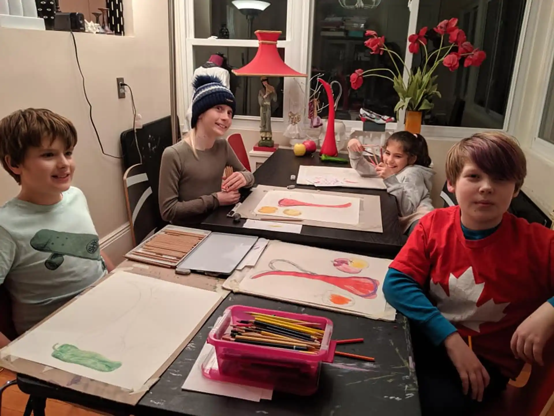a group of children sitting around a table