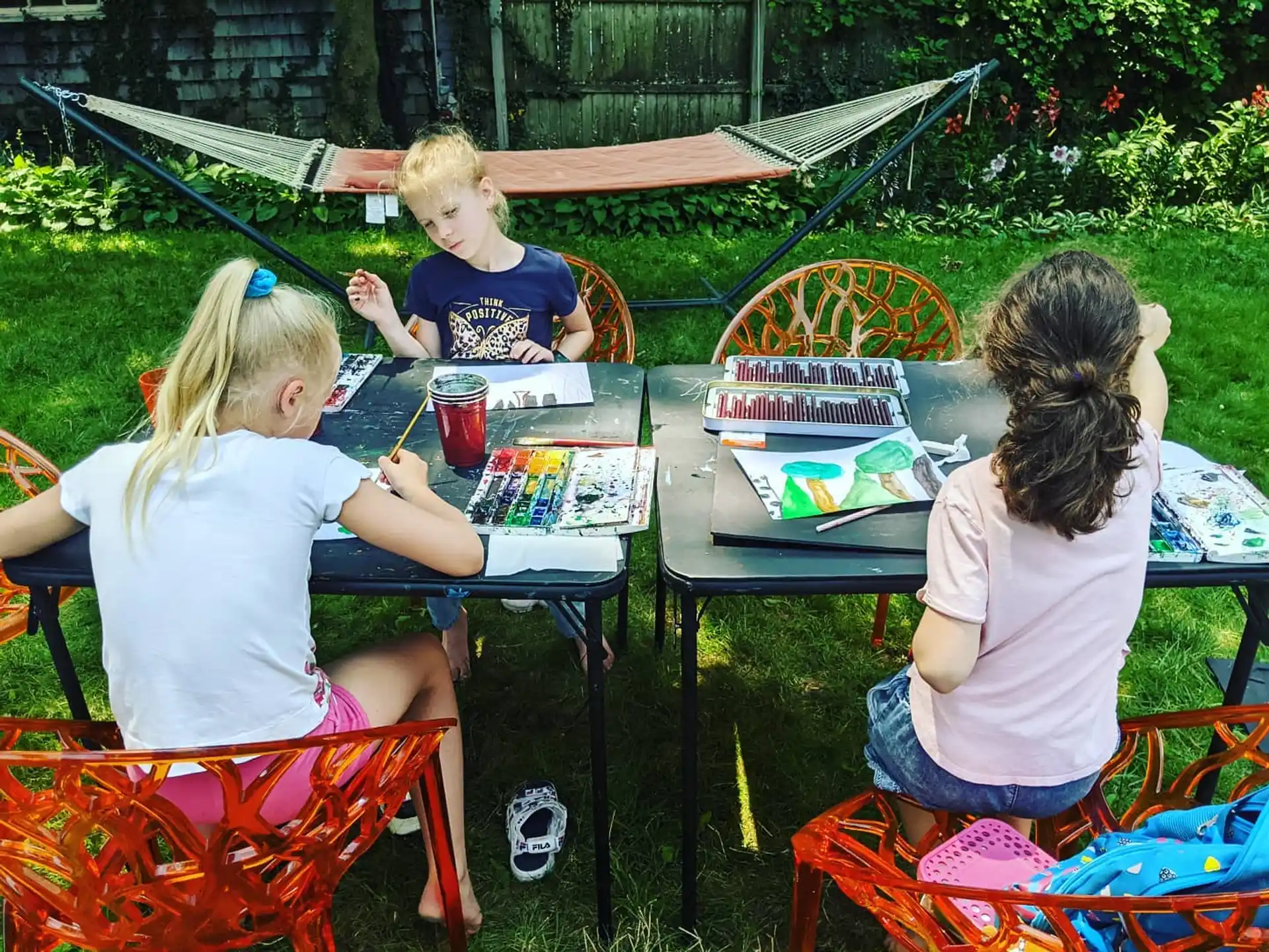 a group of children sitting at a table playing a game