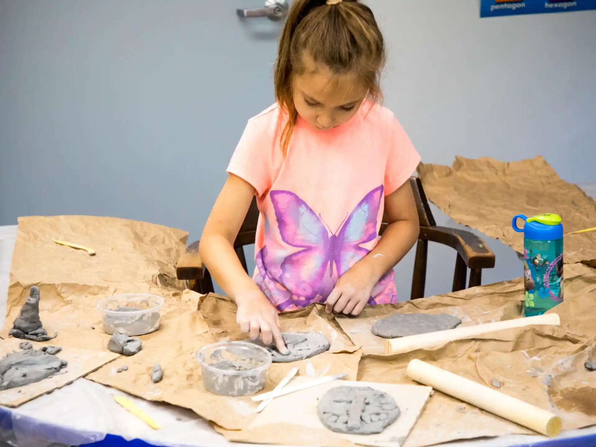 a girl painting on a table