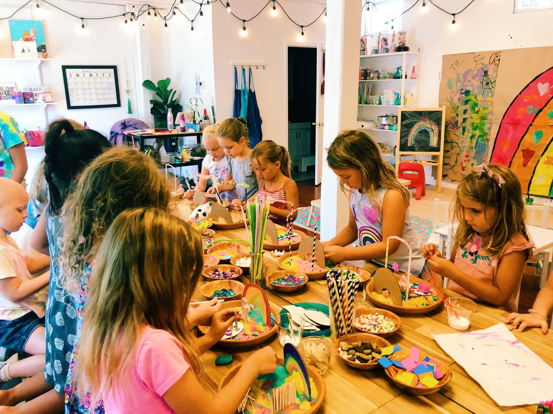 a group of children eating at a table