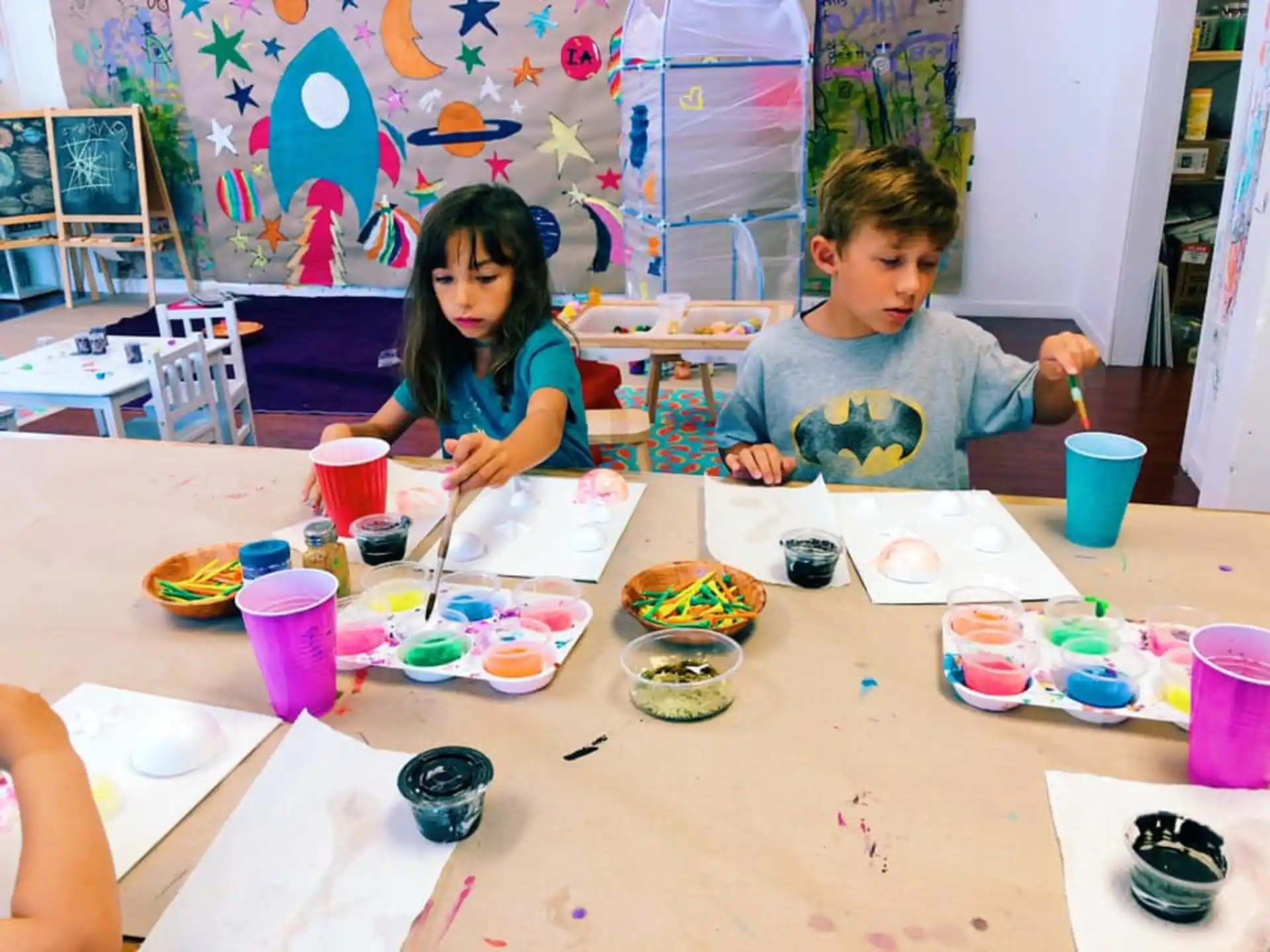 a group of children painting