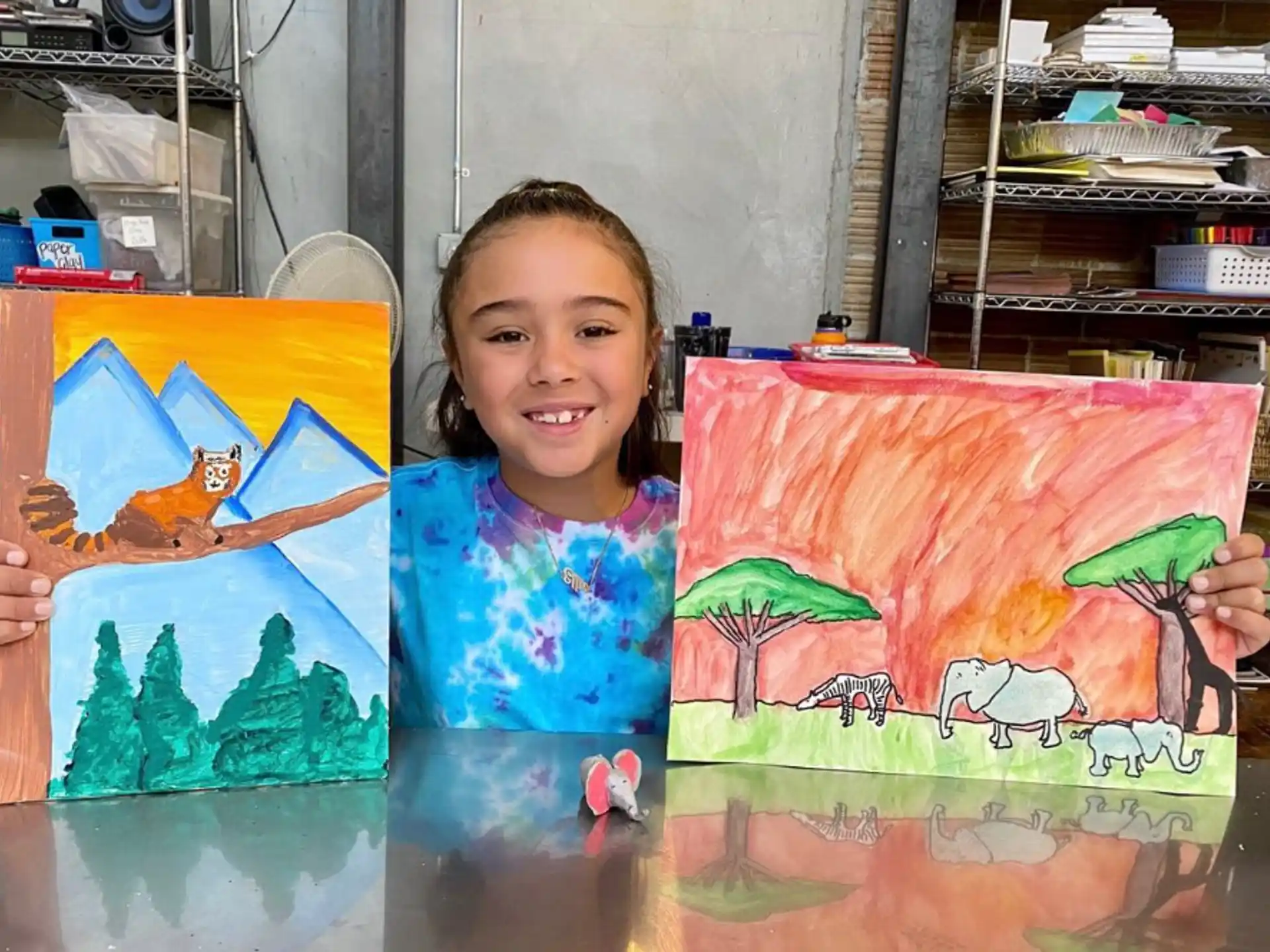 a girl holding paintings