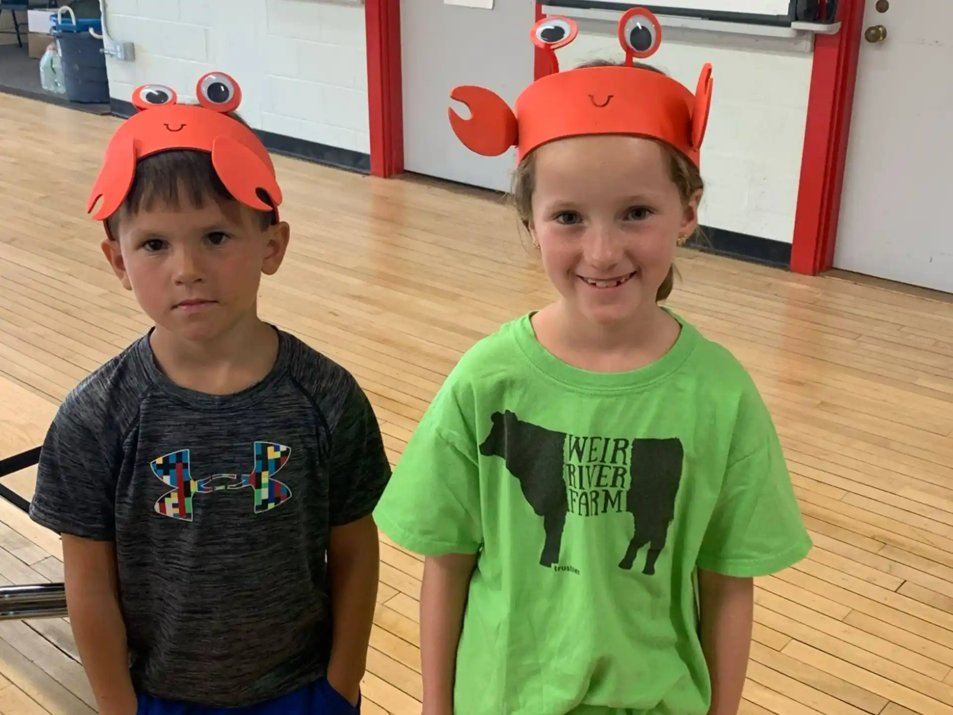 two boys wearing red hats