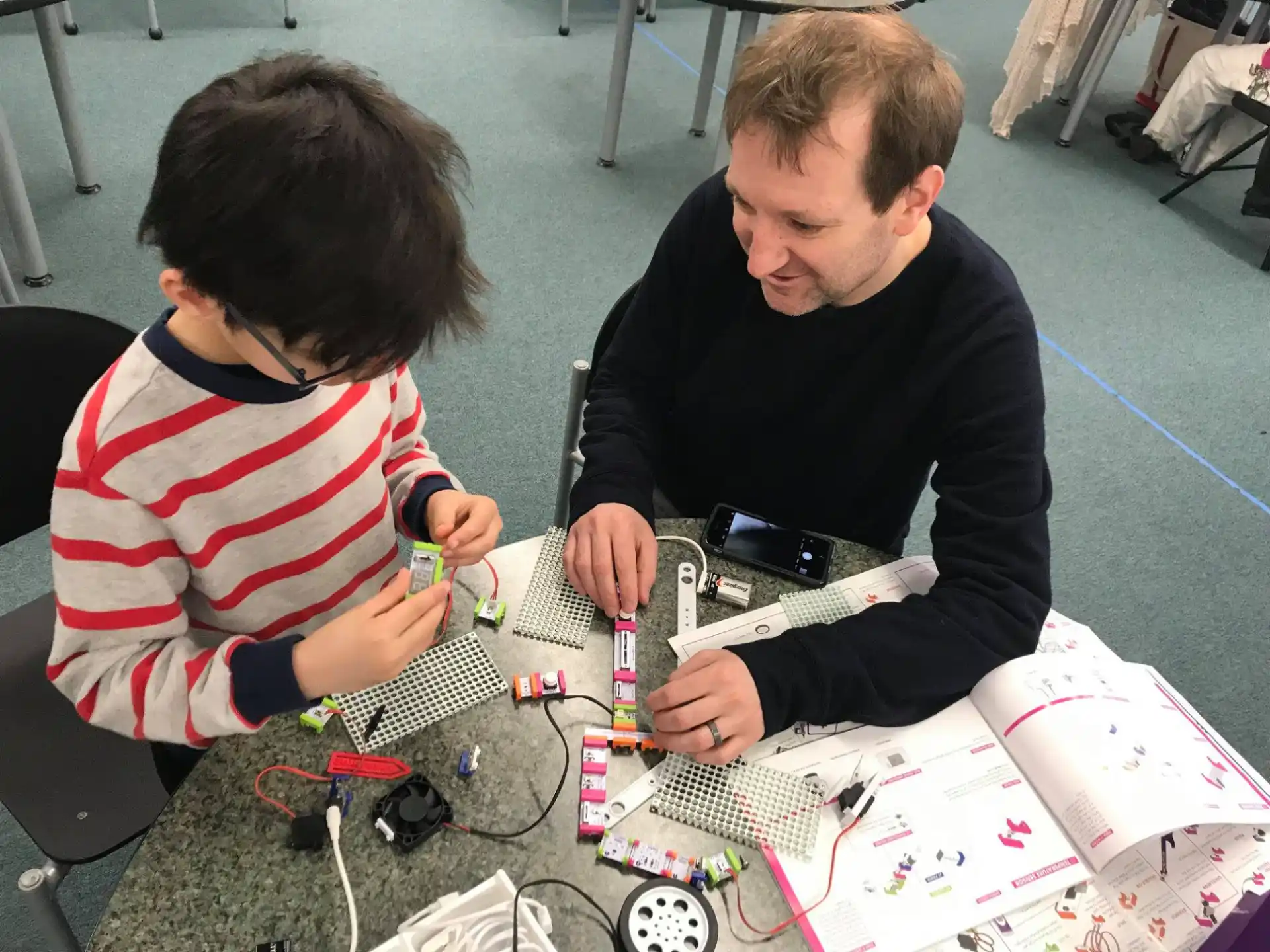 a person and a boy playing with a toy