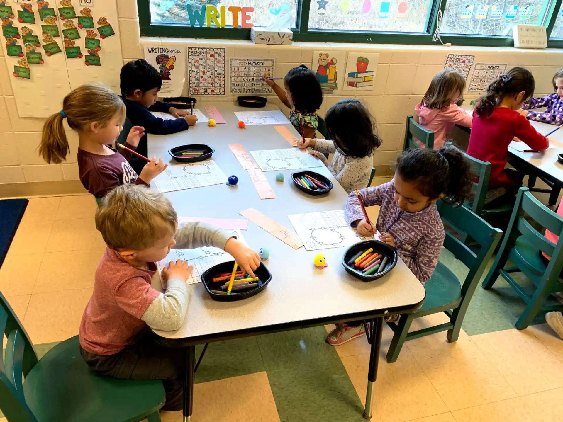 a group of children sitting around a table eating