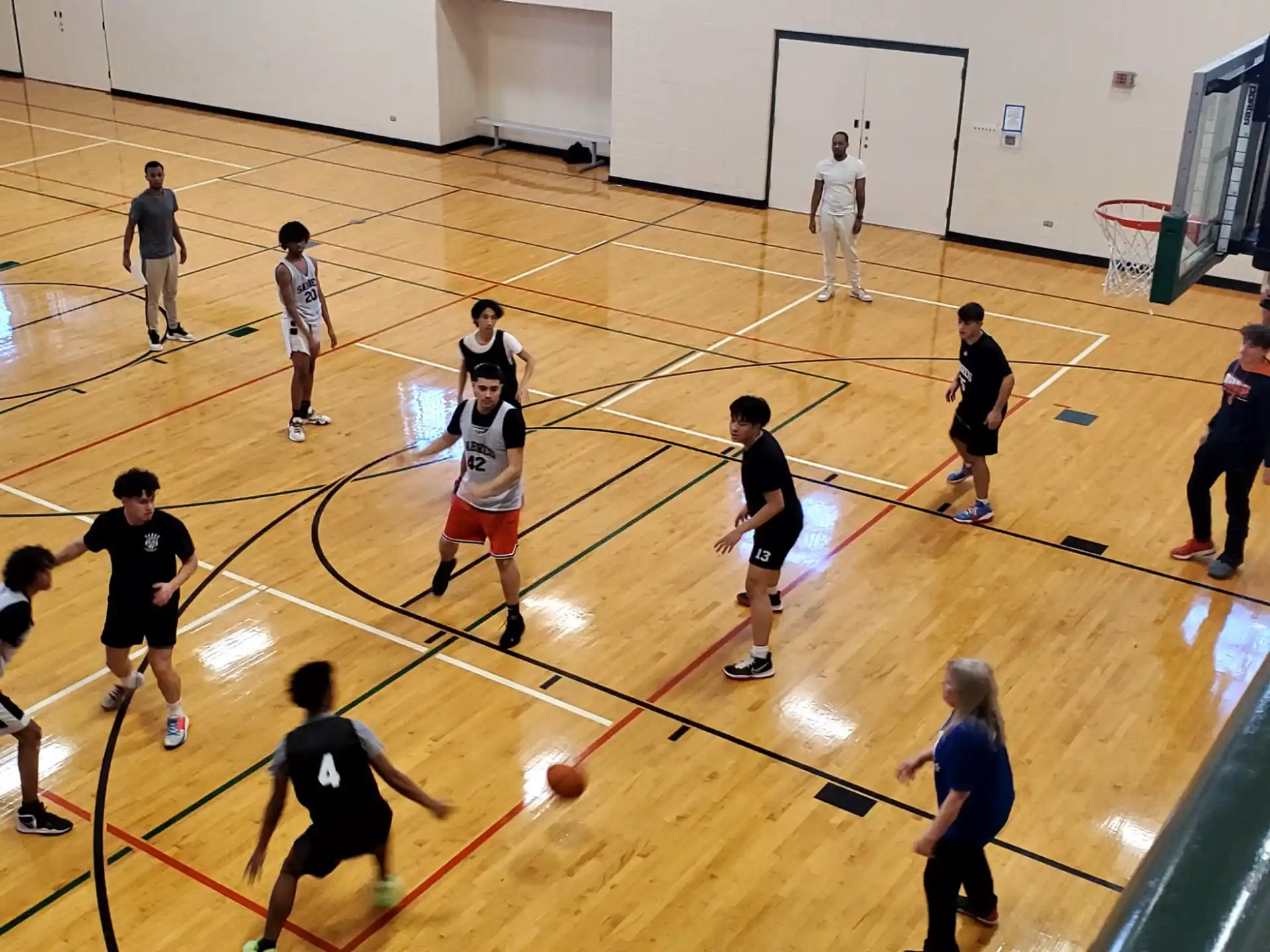 a group of people playing basketball