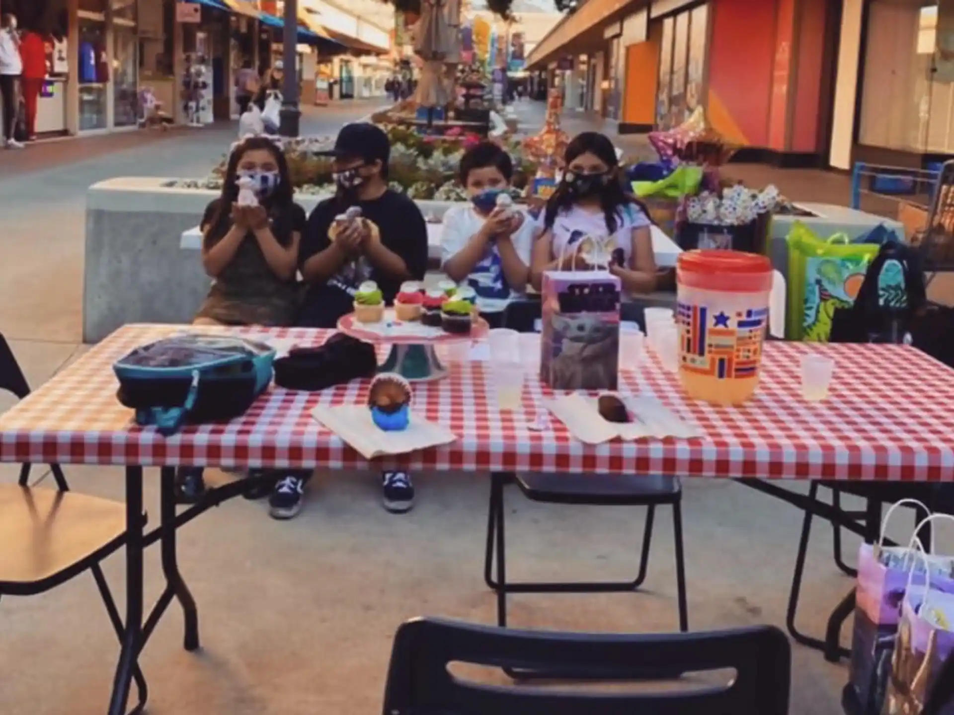 a group of people sitting at a table eating food