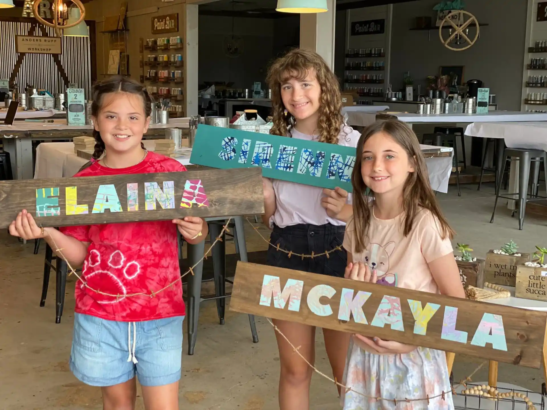 a group of girls holding a sign