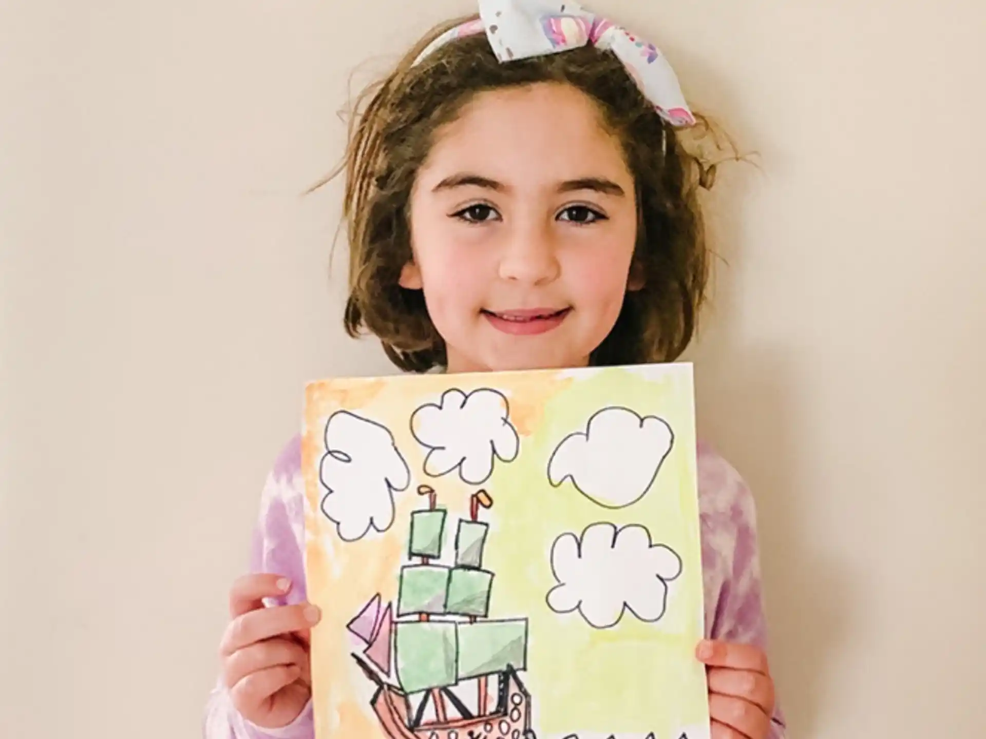 a girl holding a drawing