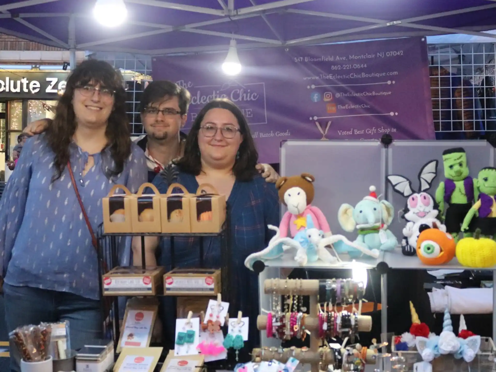 a group of people holding a box of stuffed animals