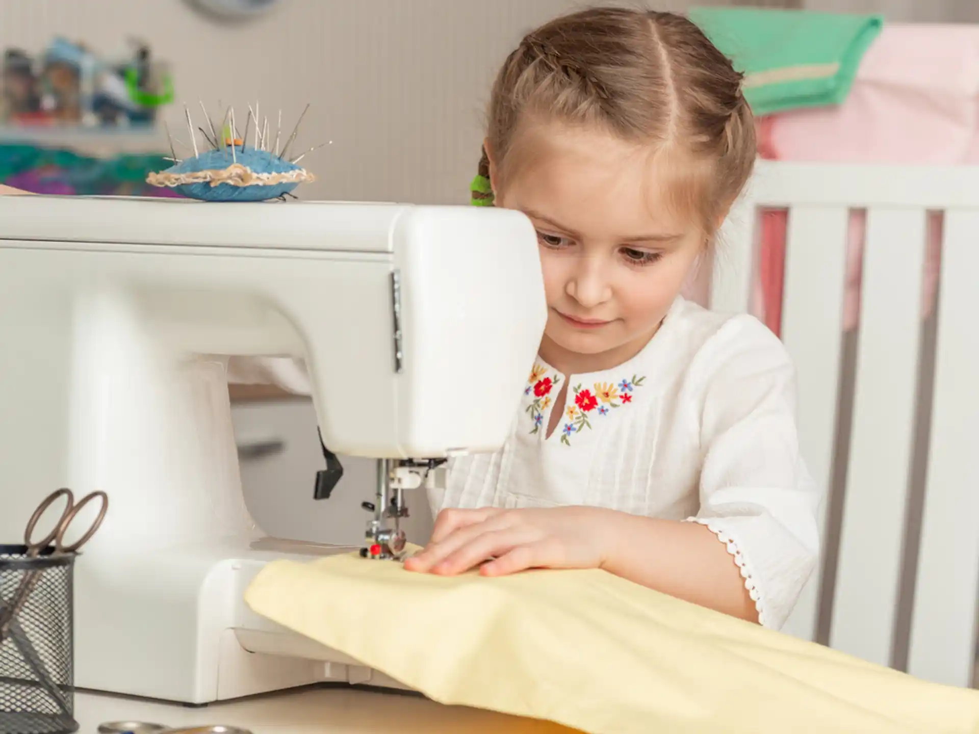a child using a sewing machine