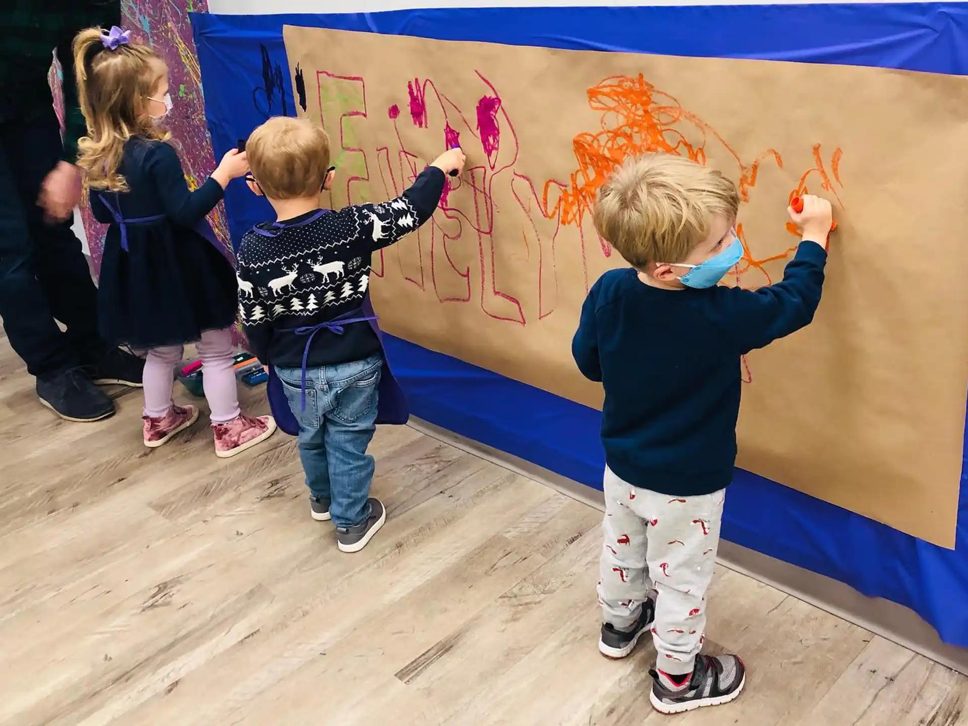 children painting on a wall